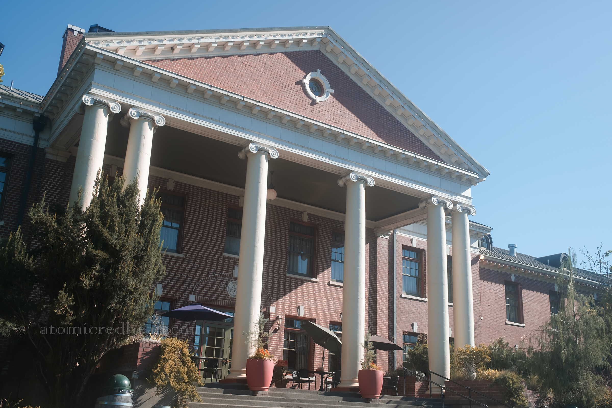 Exterior of Grand Lodge, a Greek revival style portico with columns, with the building itself made of brick.