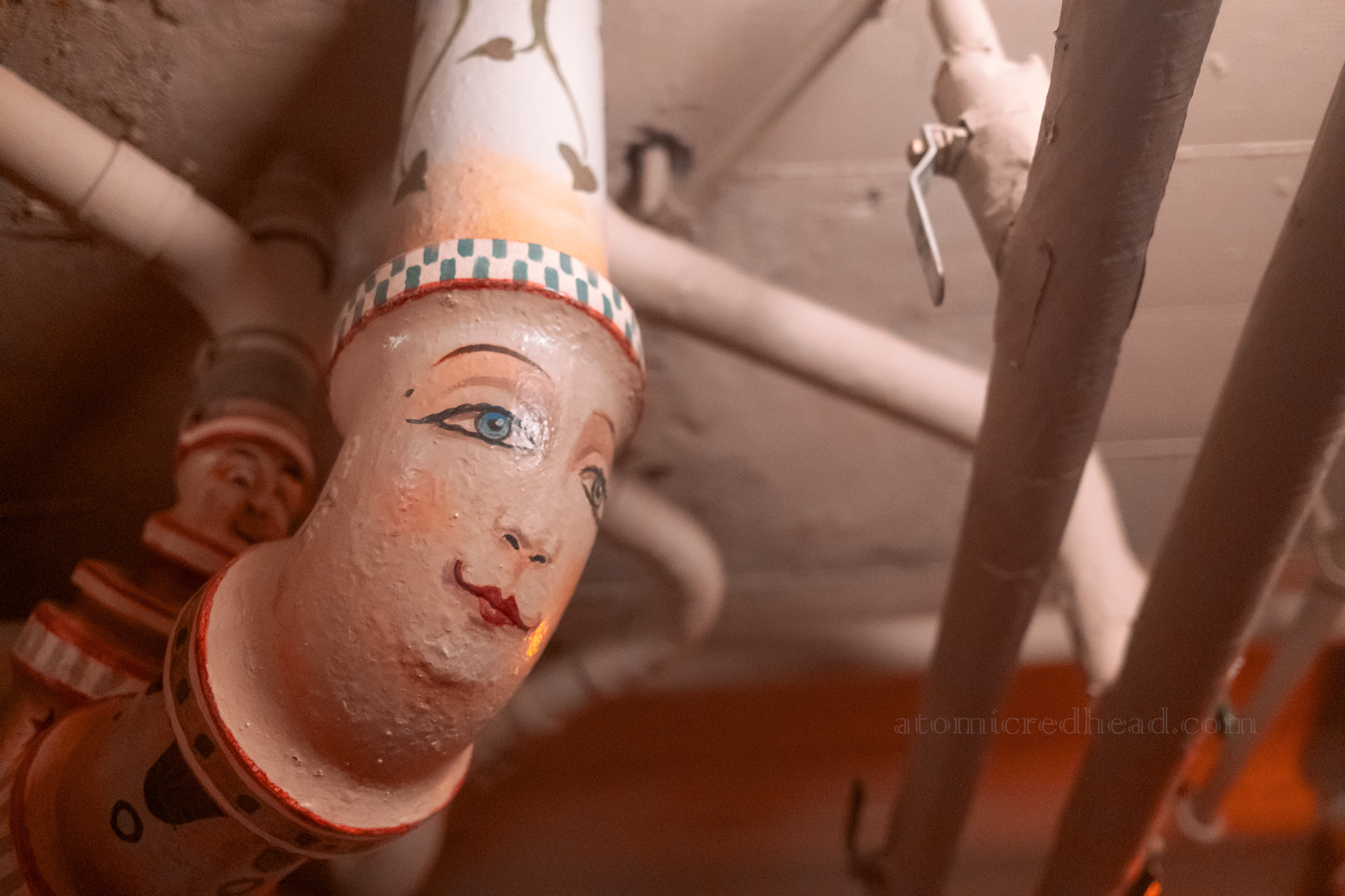 Close-up of a face painted on a pipe.