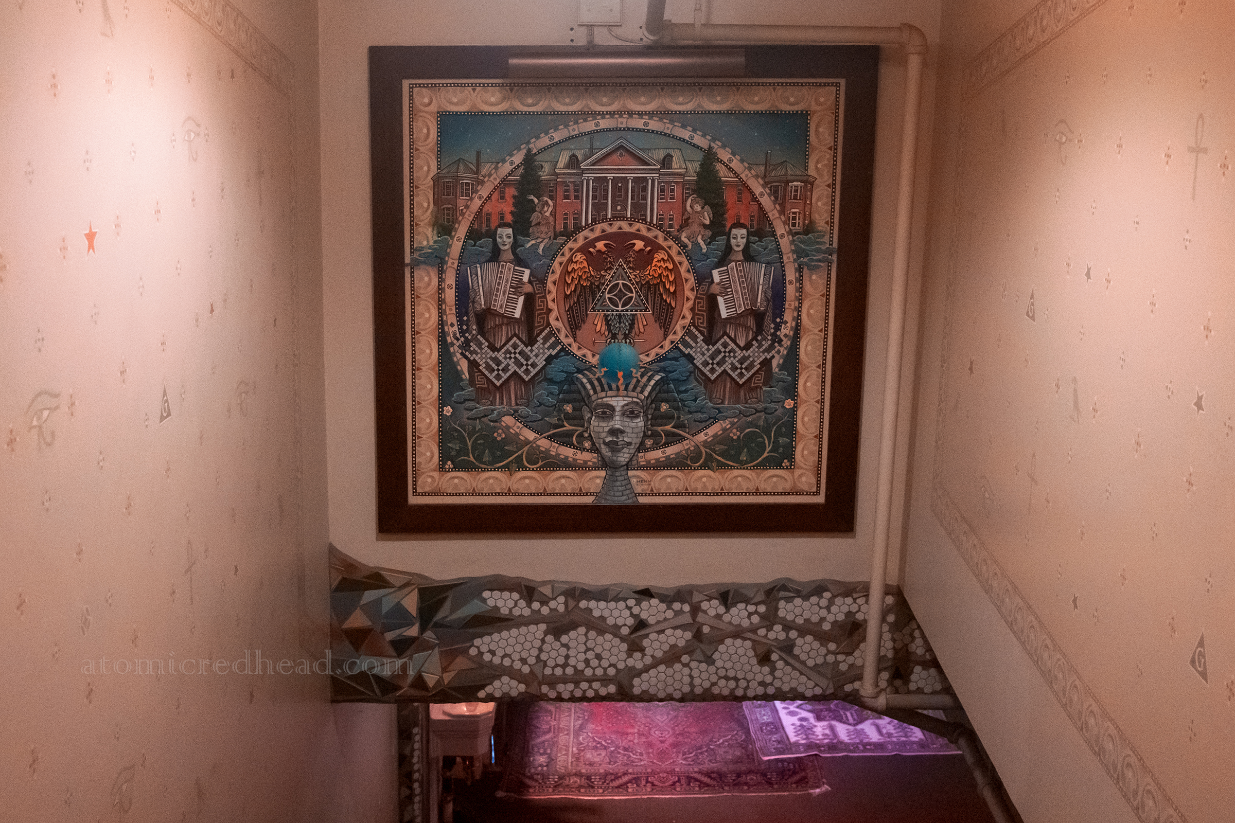 A mural featuring Egyptian motifs, the Lodge, and women playing the accordian. 
