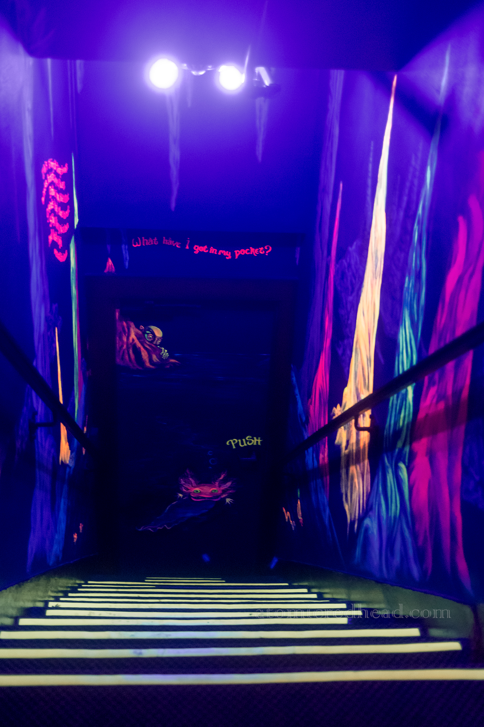 Stairs down toward a door with Golum at the bottom.