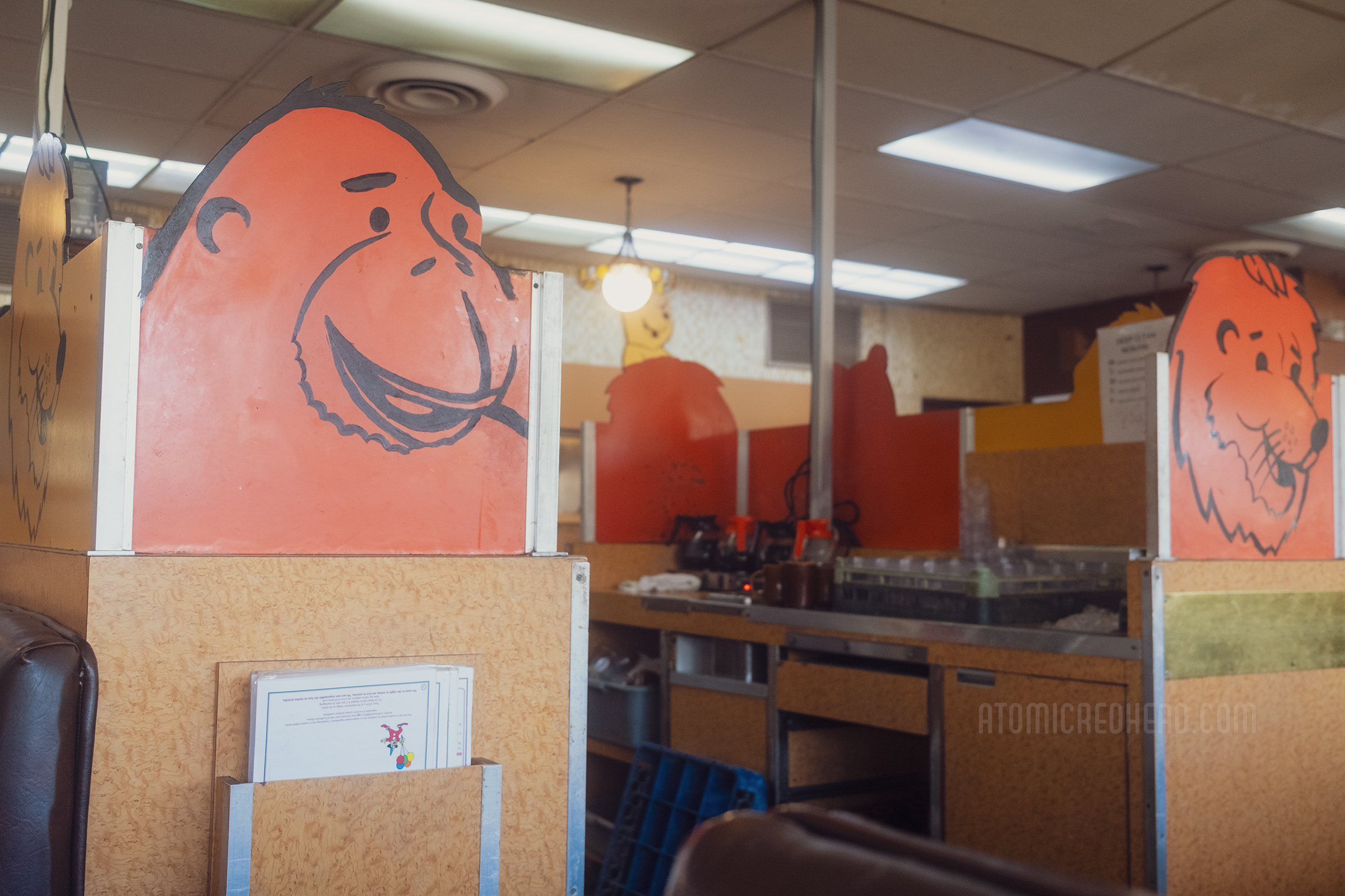 A service station in the middle has panels painted with various circus animals, including a gorilla and a lion.