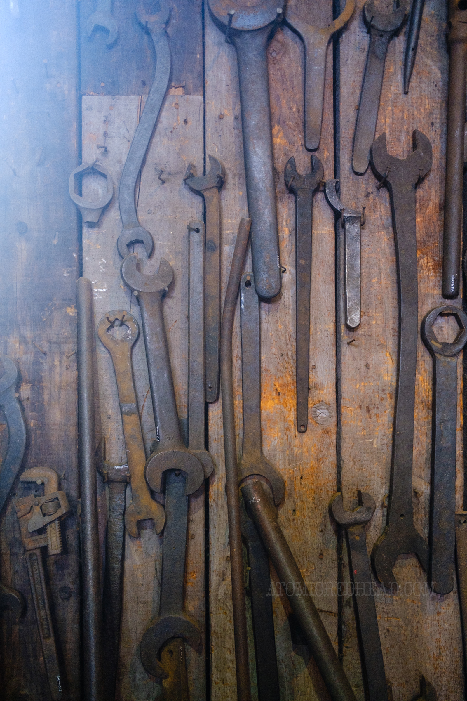 A wall filled with various wrenches.