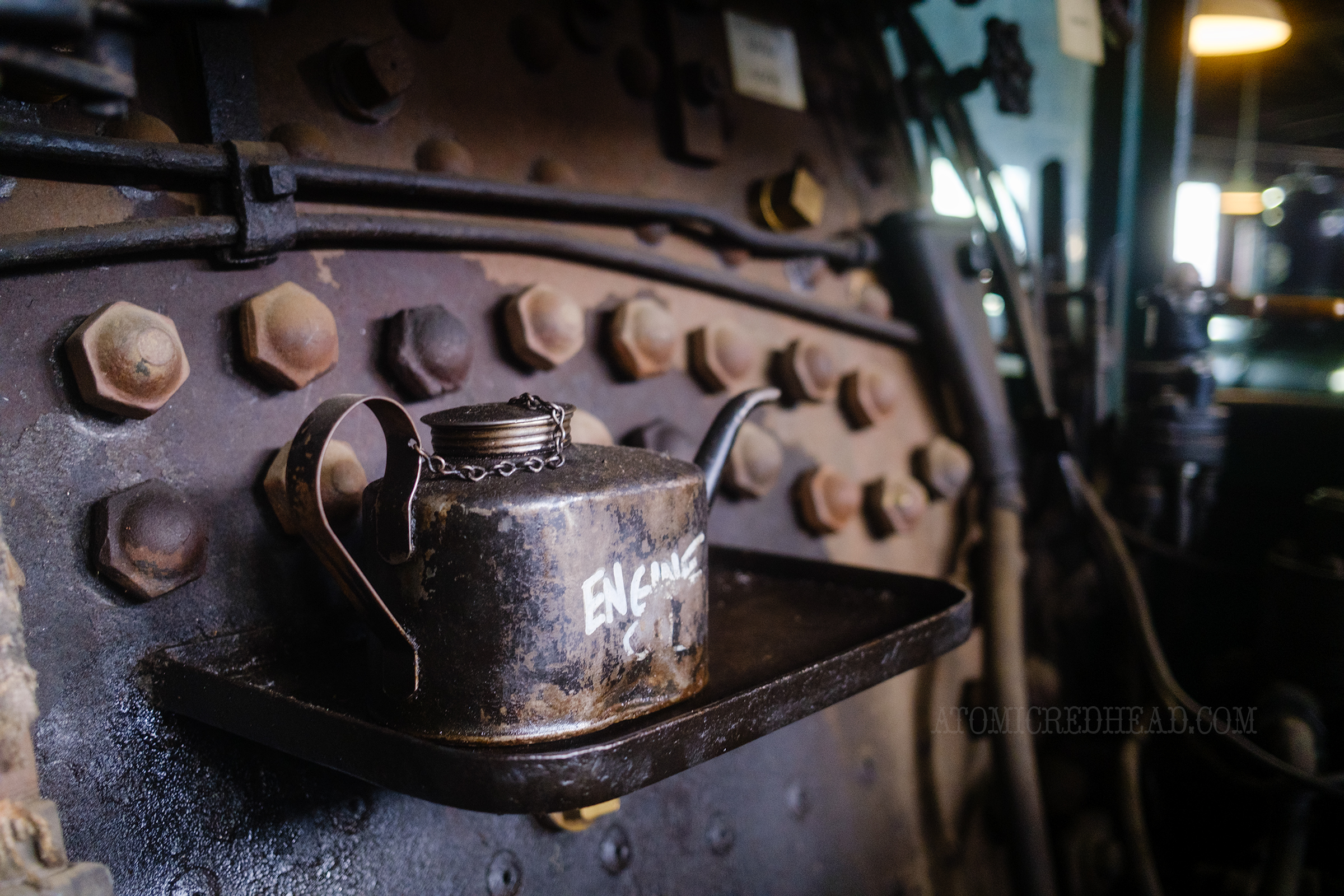 Close-up of an oil can sitting inside one of the cabs.
