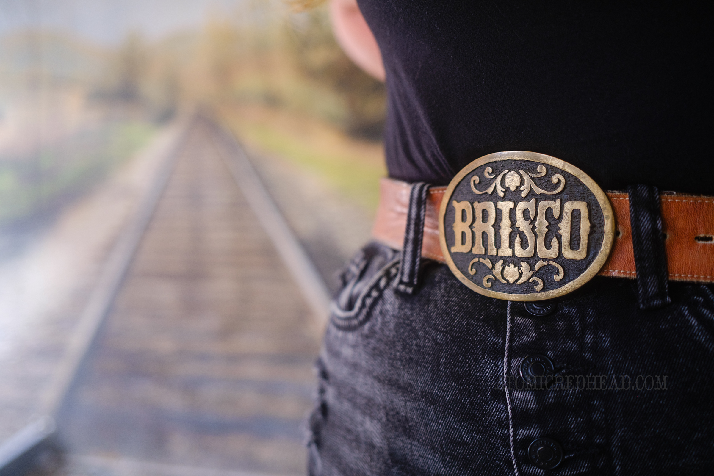 Close-up of a Brisco belt buckle, reading "Brisco" in a western font.
