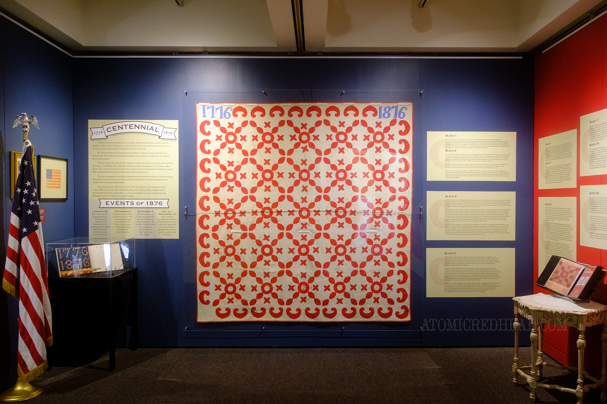 A red and white quilt, made to celebrate America's cenntenial.