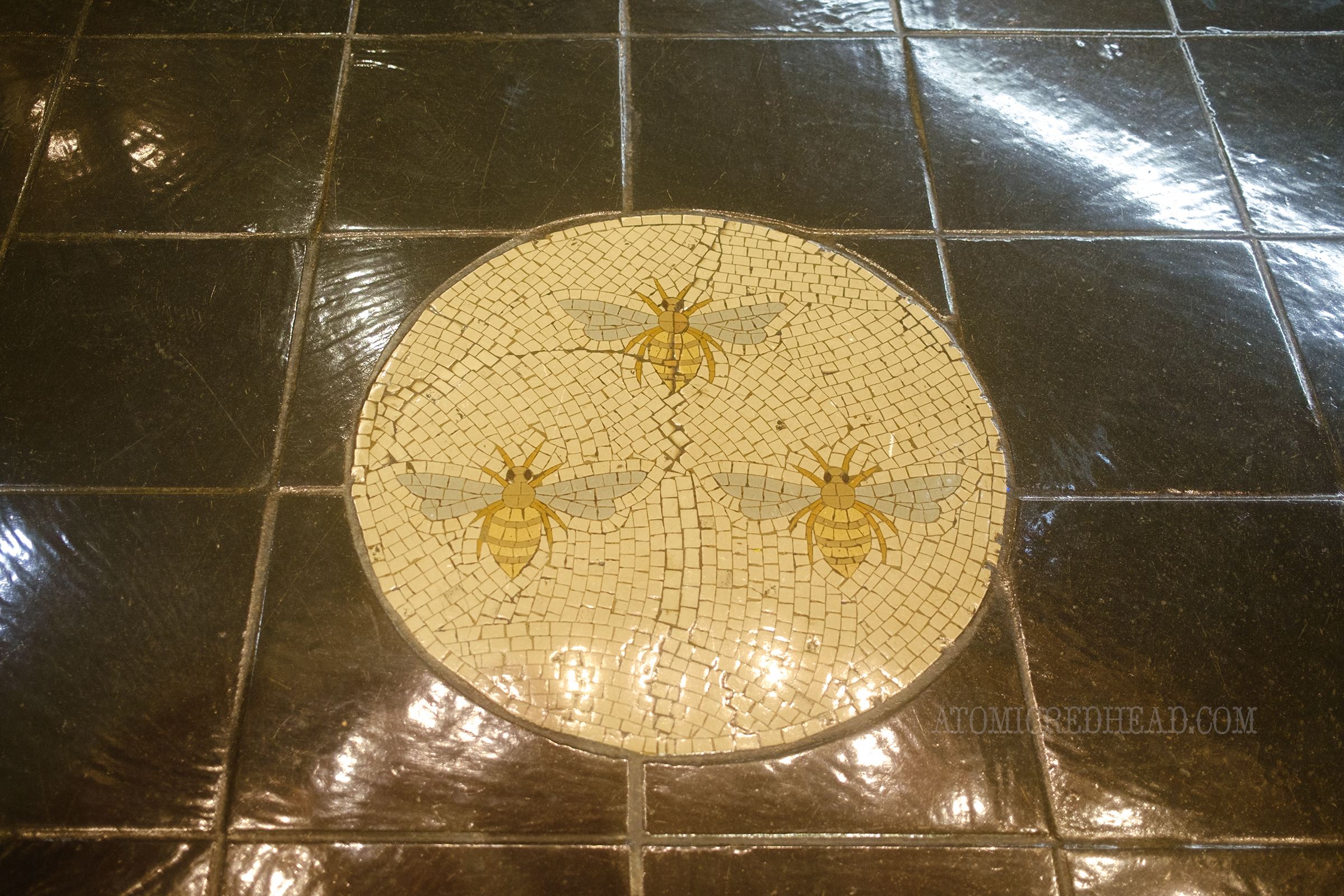 A mosaic of three bees.