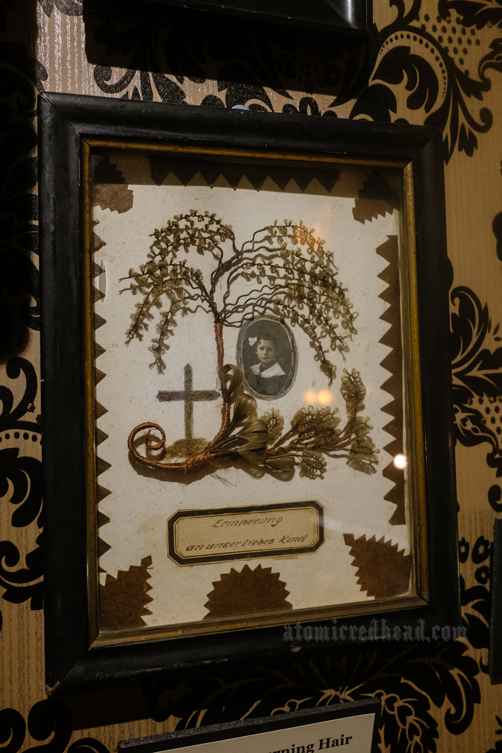 Victorian mourning hair art, made up to look like a tree and a cross.