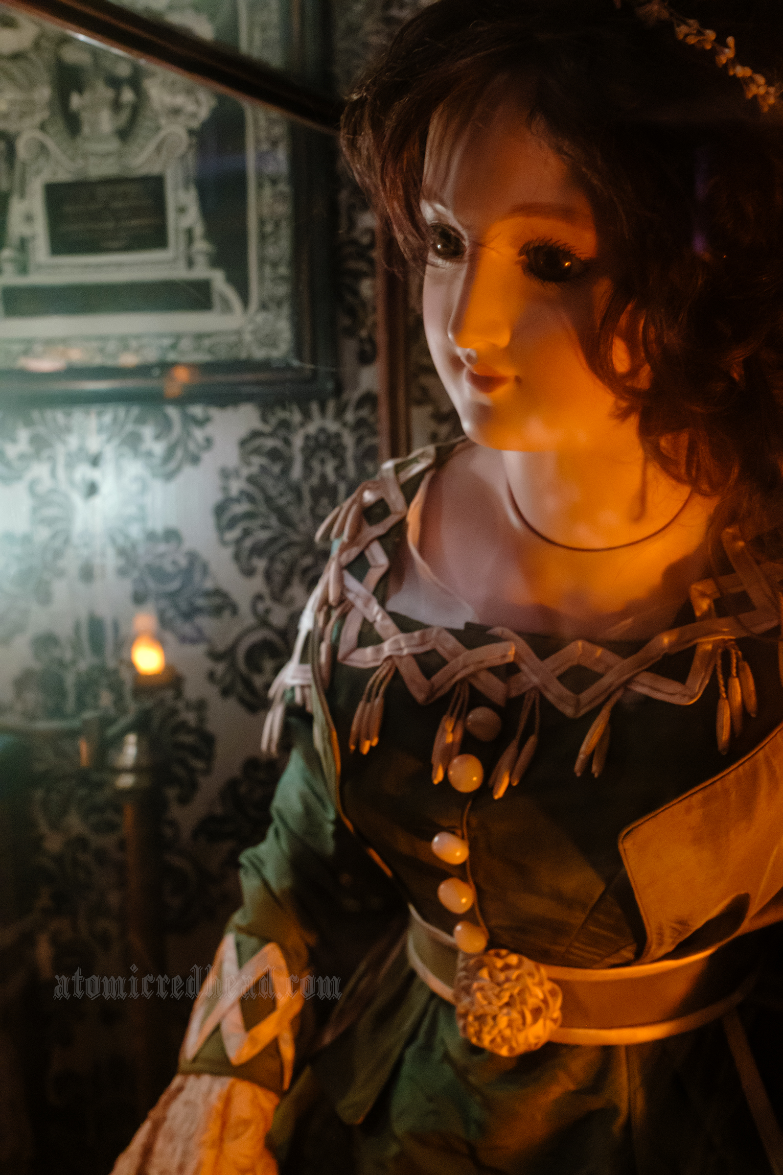 A mannequin dressed in a green dress.