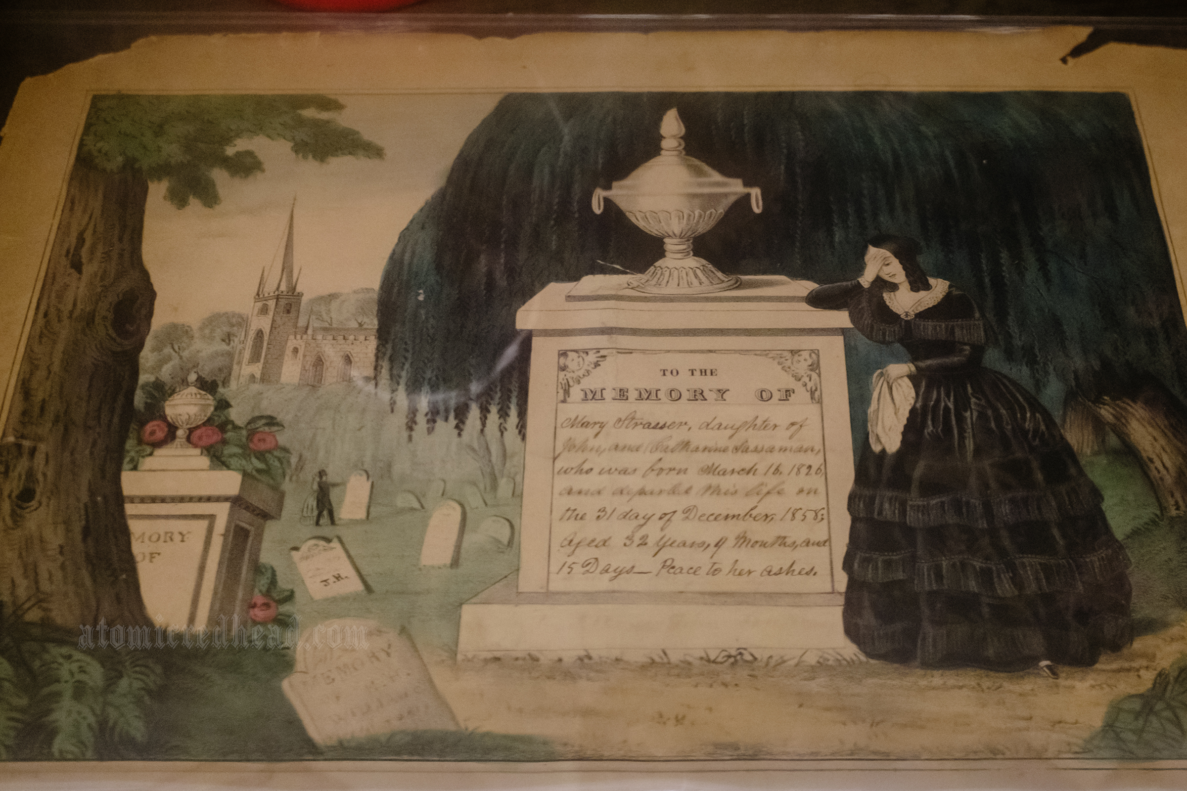 An illustration of a woman grieving on a tombstone.