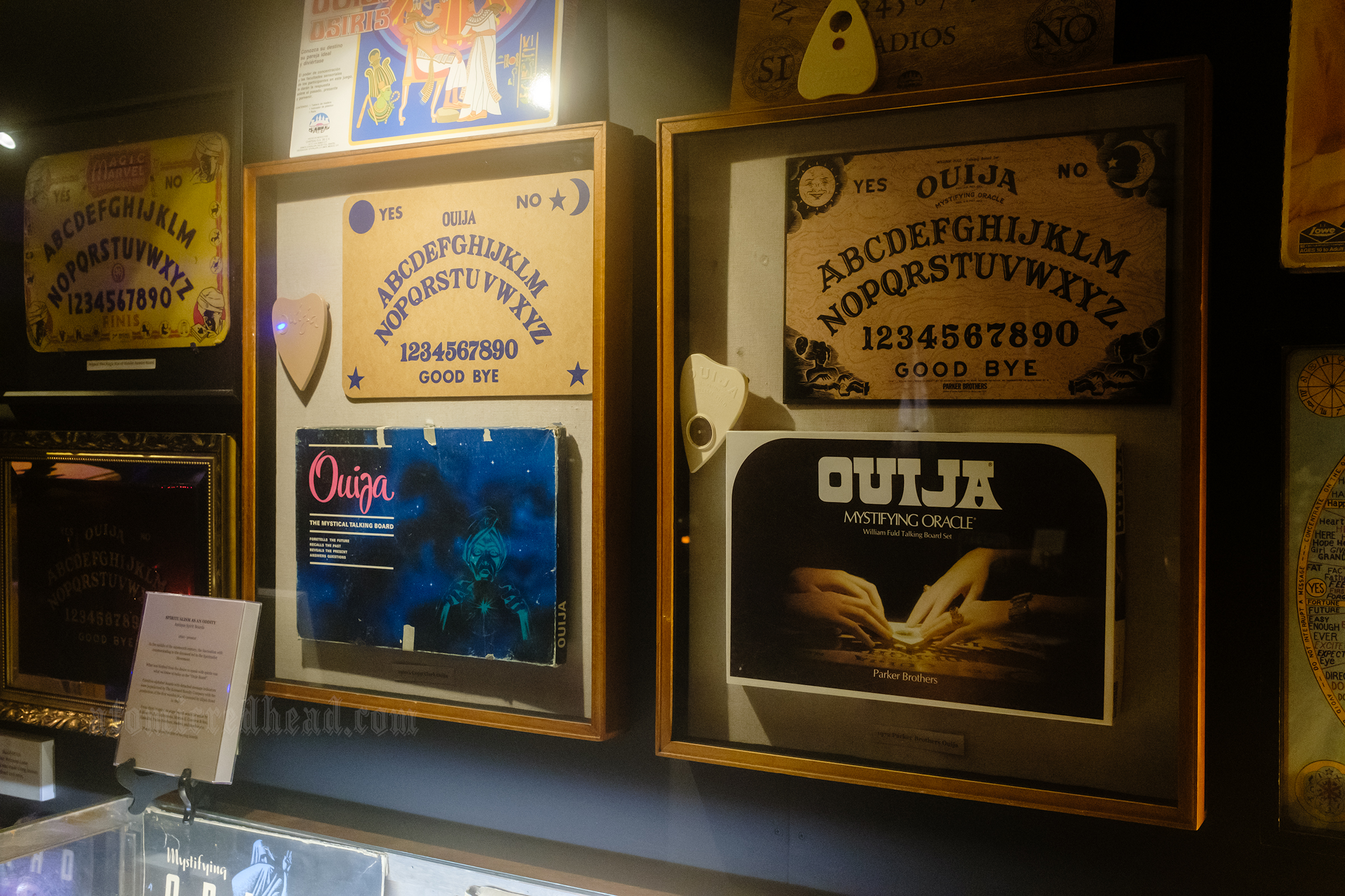 A wall featuring multiple framed Ouija boards.