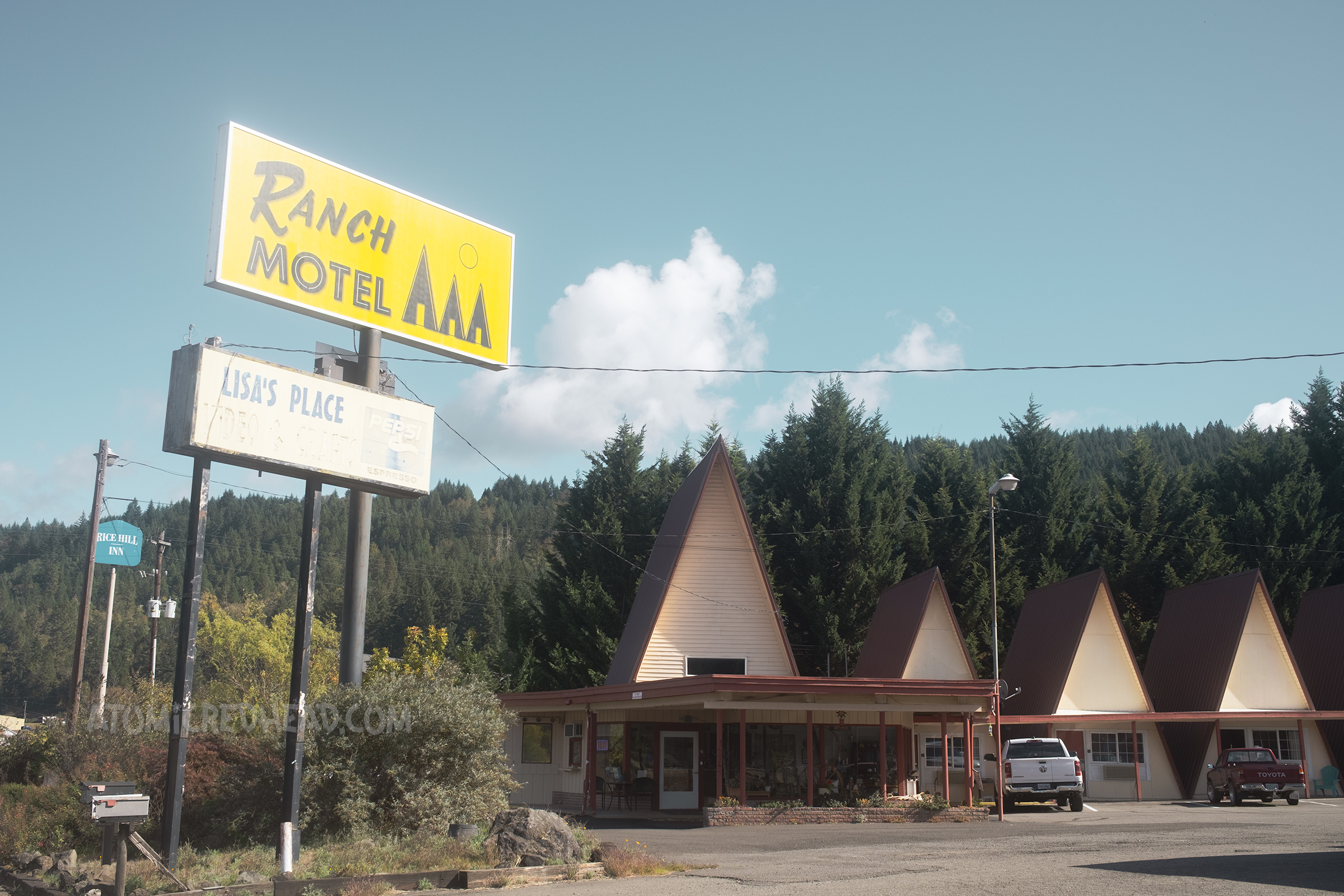 Several small A-frame buildings make up the Ranch Motel.