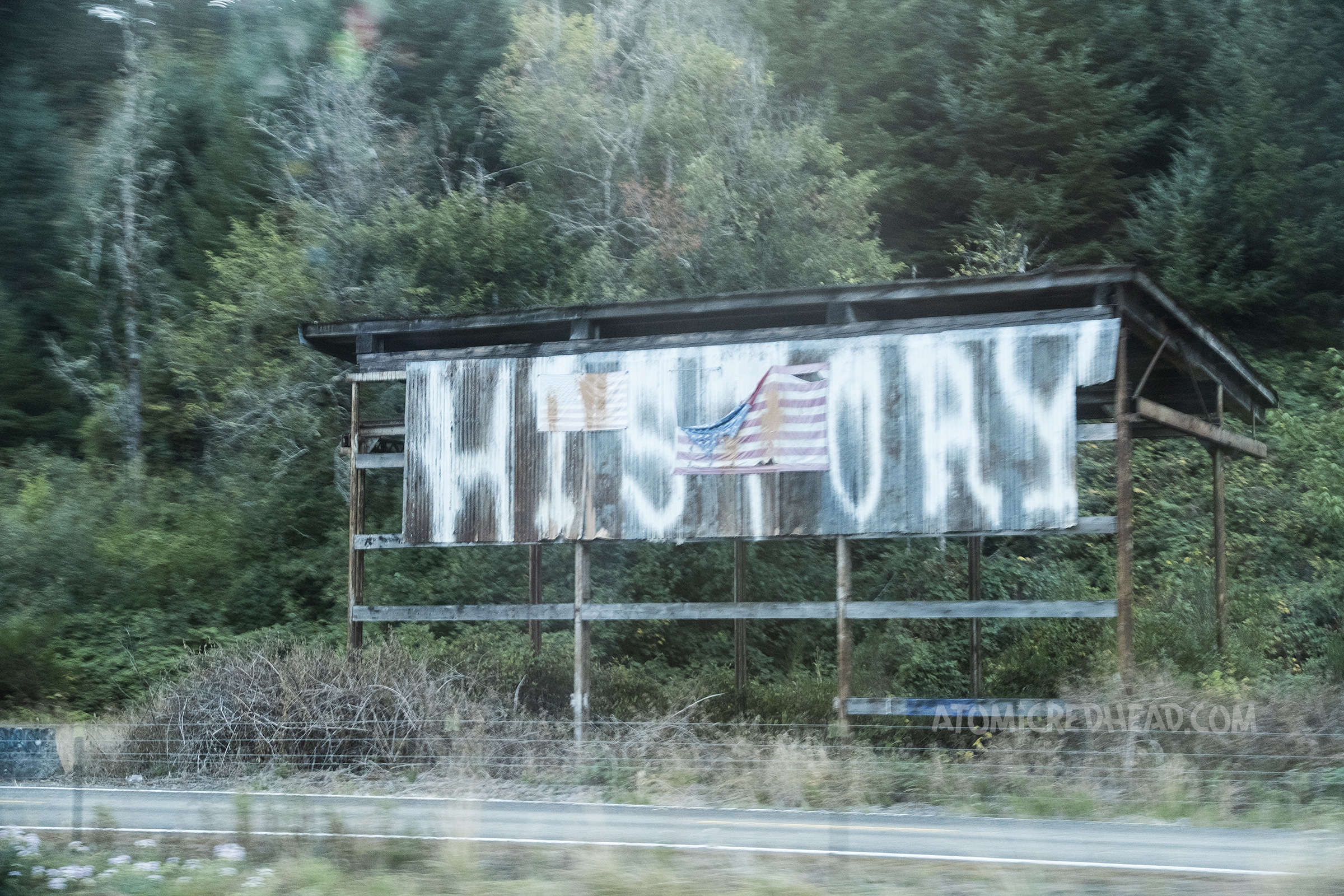 A massive sign simply reads "HISTORY" in white spray painted letters.