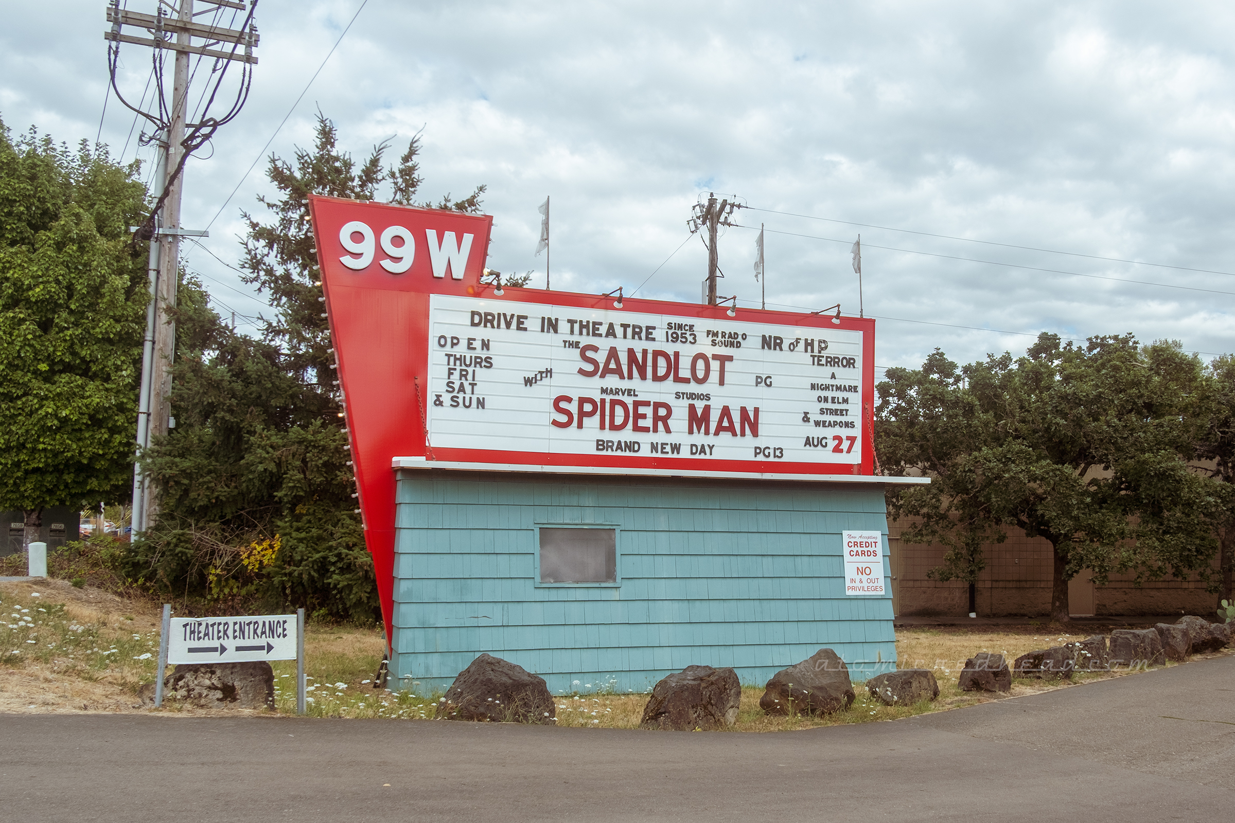 Marquee for the 99W, a red, green, and white sign advertises the films playing, The Sandlot and Spider-Man.