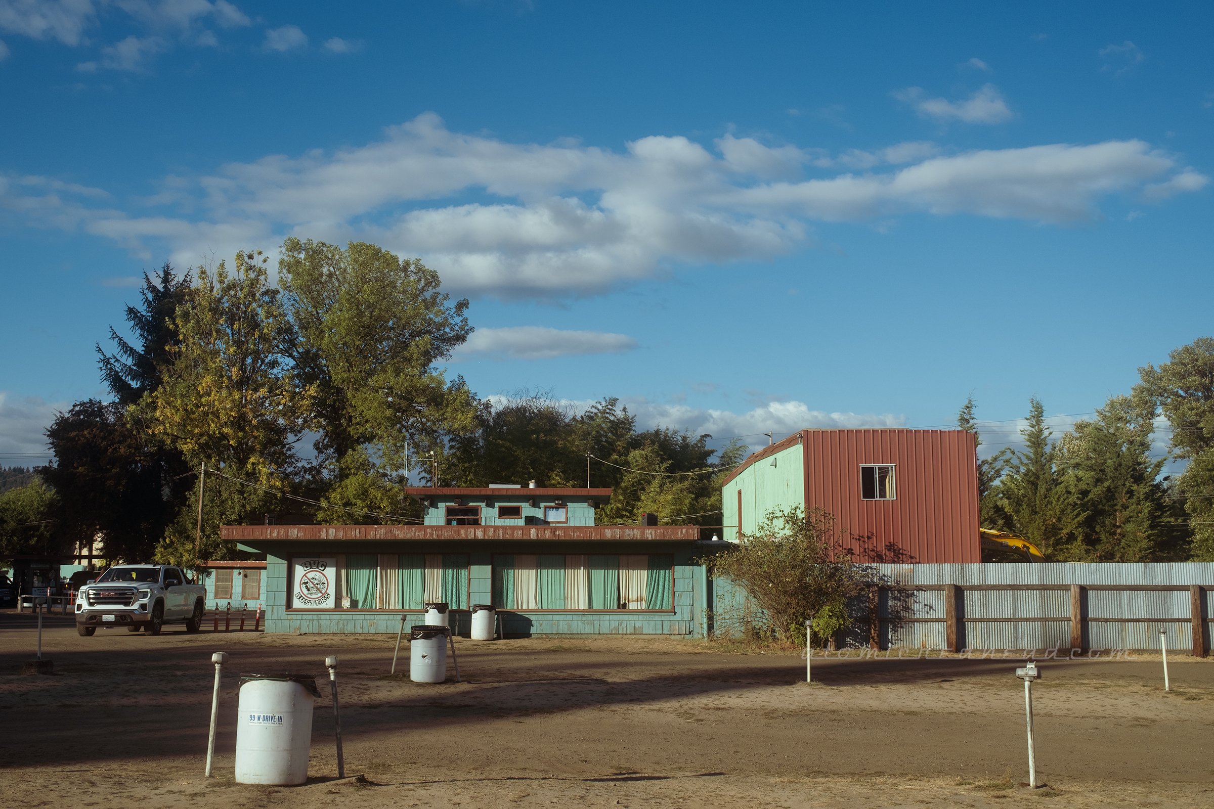 View of the concession stand, a green building with red accents.