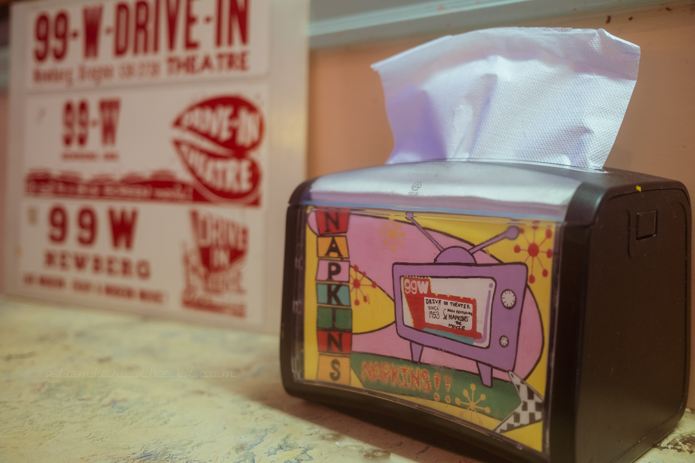 A napkin holder decorated with the sign of the 99W.