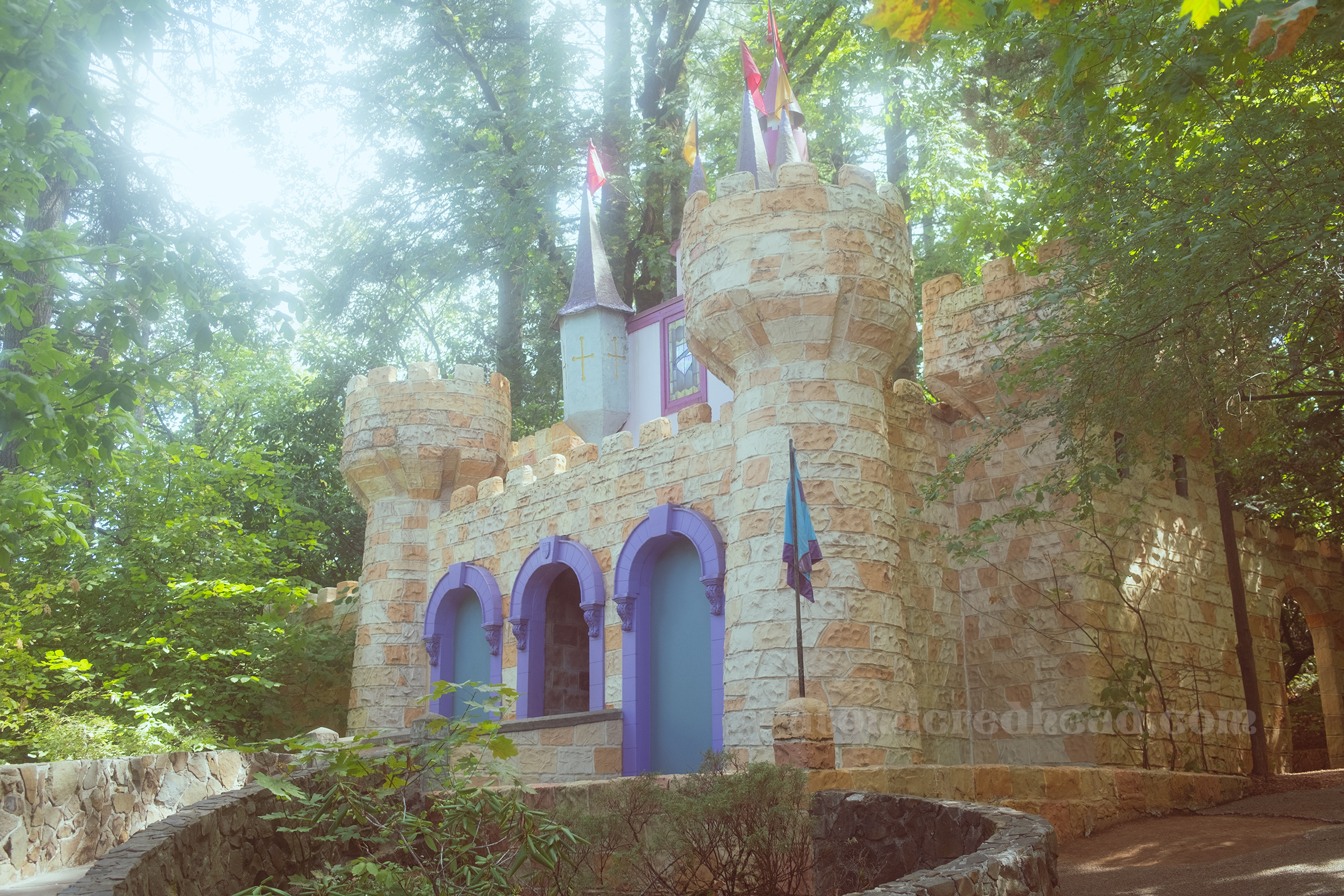 A fairytale castle with pink, purple, and blue details.