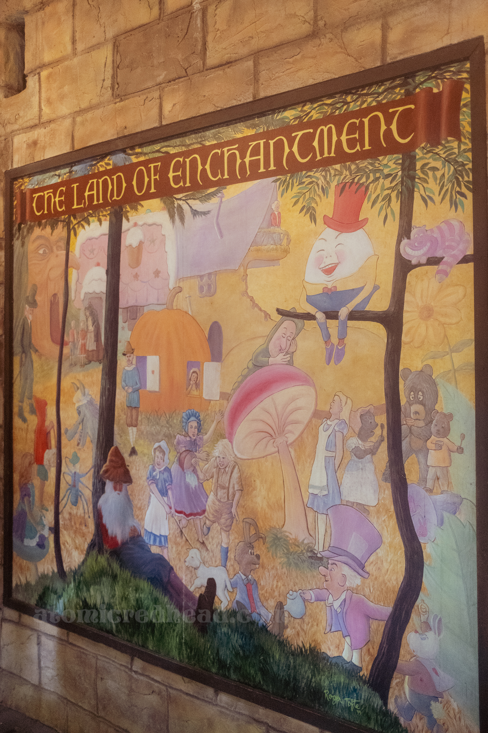 A large mural featuring various storybook characters, across the top it reads "The Land of Enchantment"