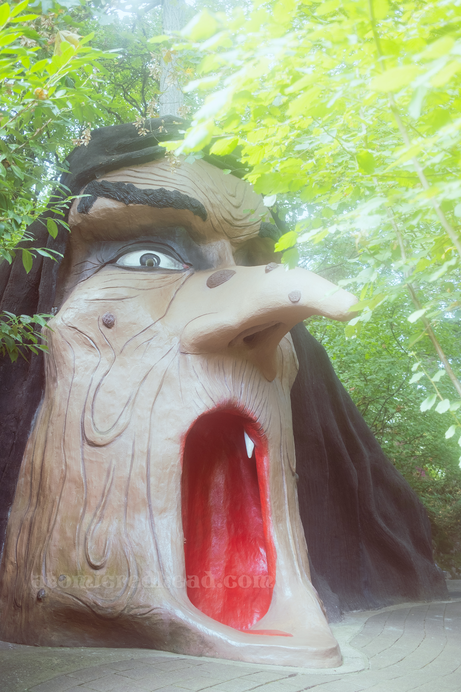 A massive witch head with her mouth open, inviting you to climb inside.