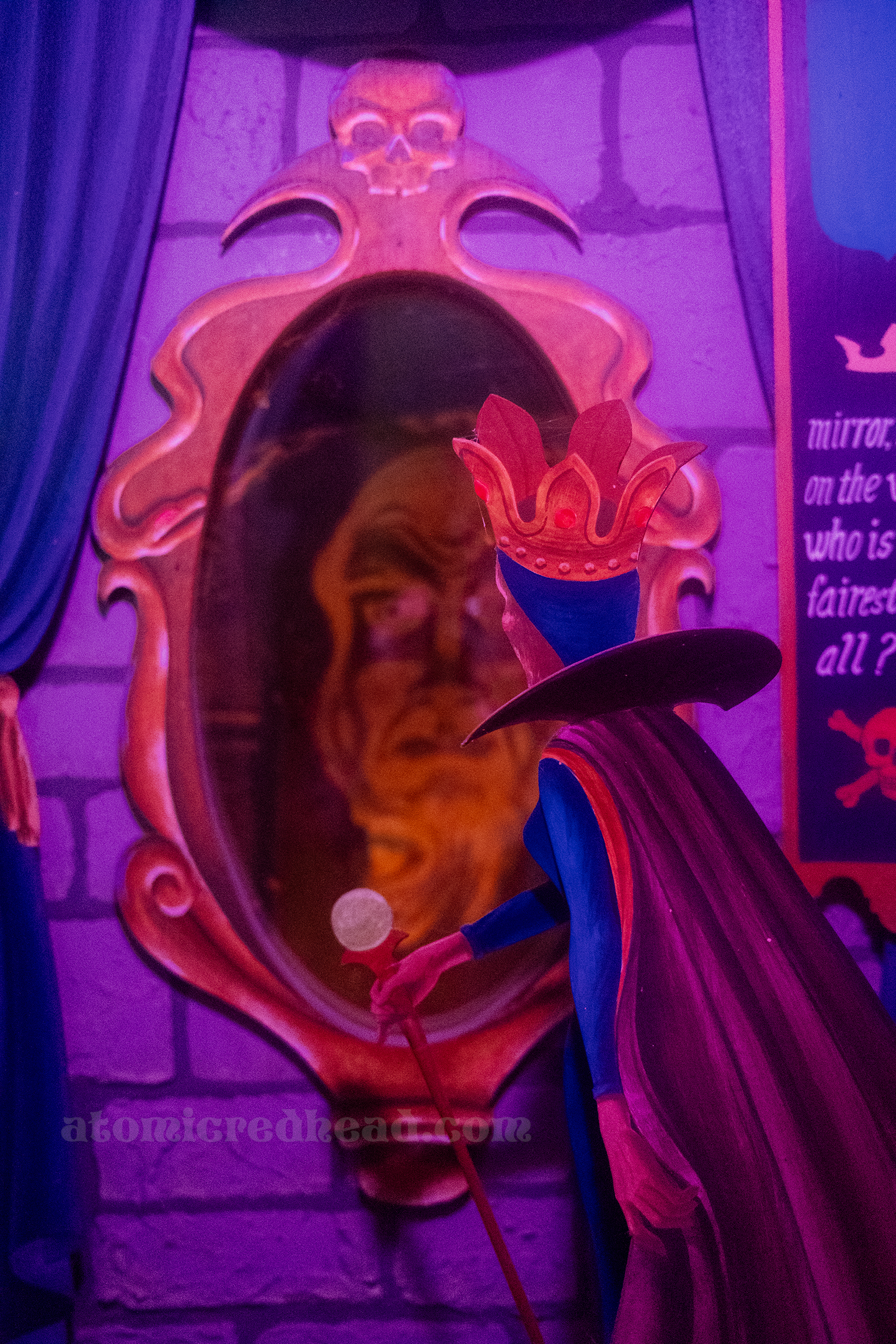 A vignette of the evil queen from Snow White looking into her magic mirror.