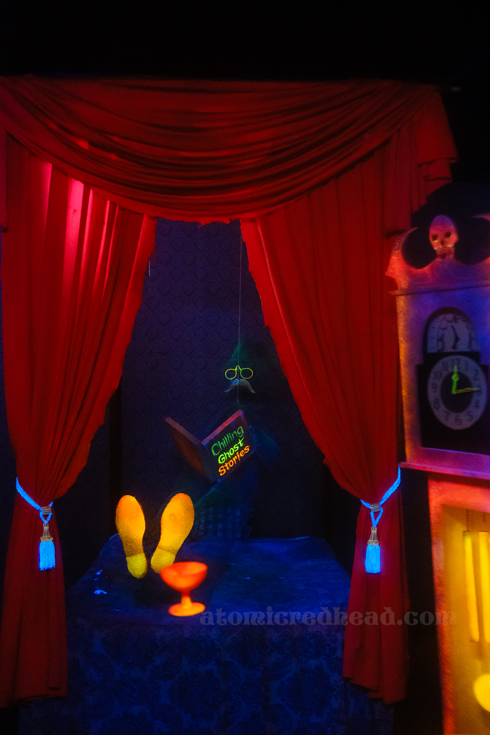 A pair of glasses, book, and pair of shoes float mysteriously in a bed inside the Haunted House.