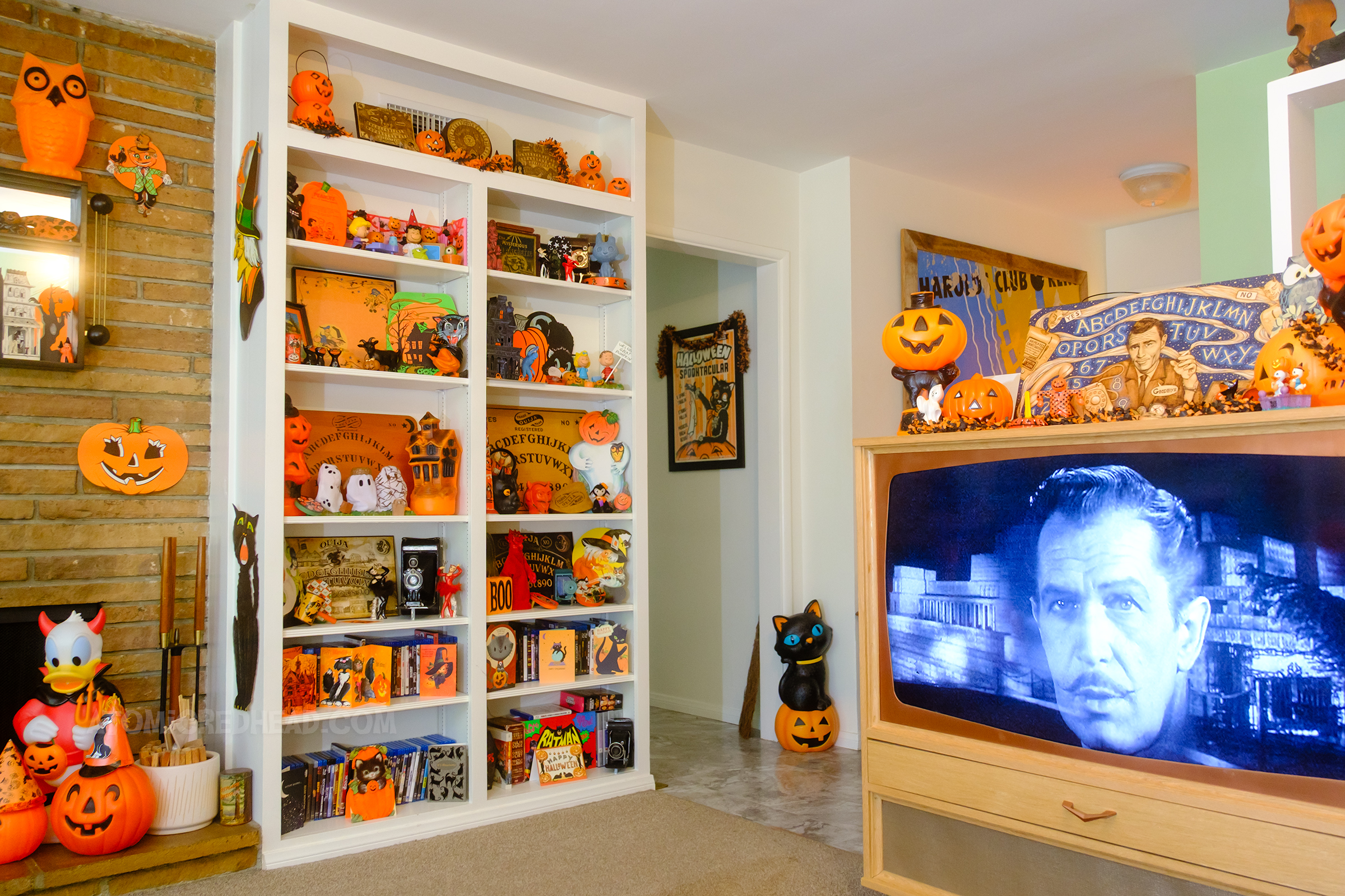 On the left is our TV with various jack o'lanterns on top, to the left is a built in bookcase with various decorations on it.