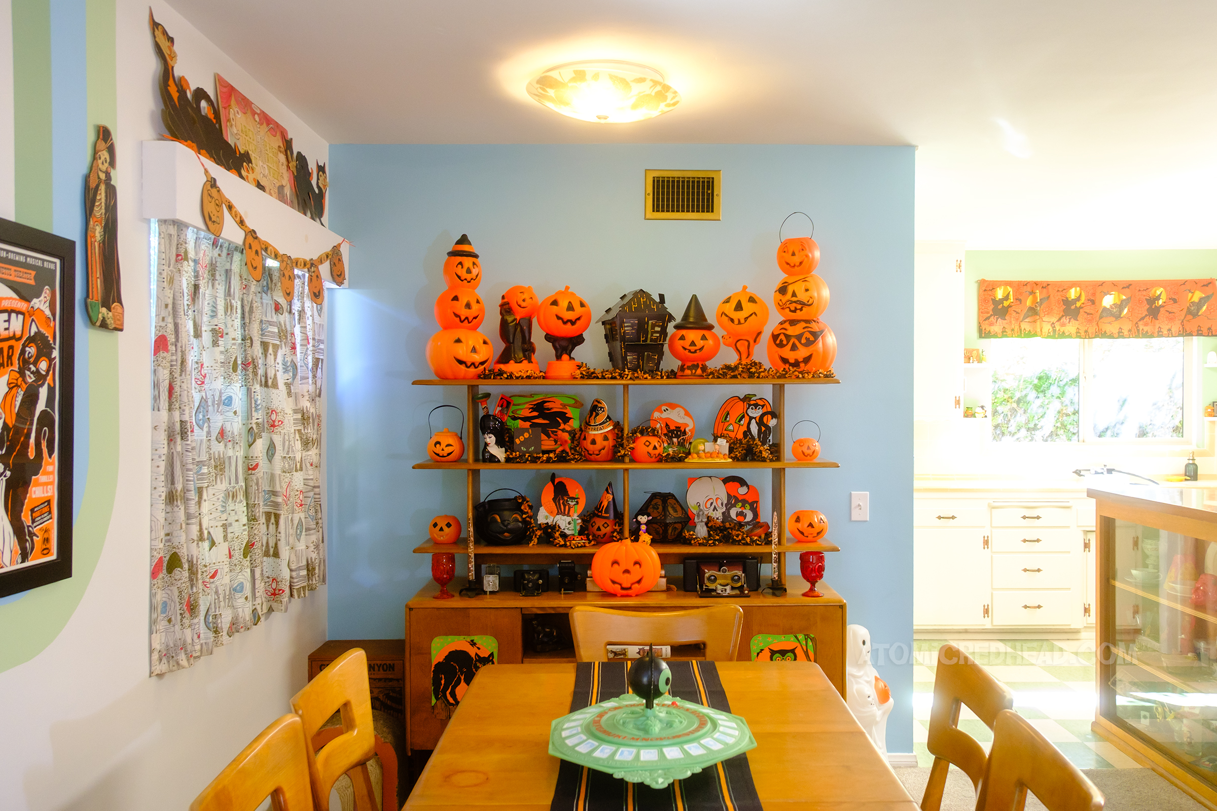 View of the shelf in our dining room, stuffed with various vintage jack o'lanterns.