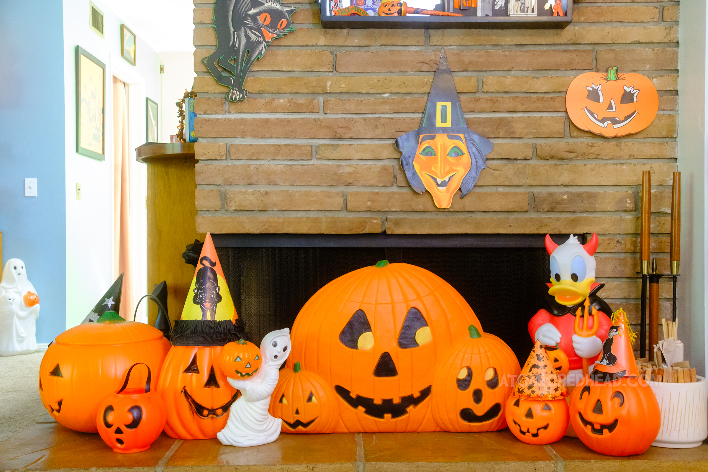 Around the fireplace are multiple vintage plastic jack o'lanterns.