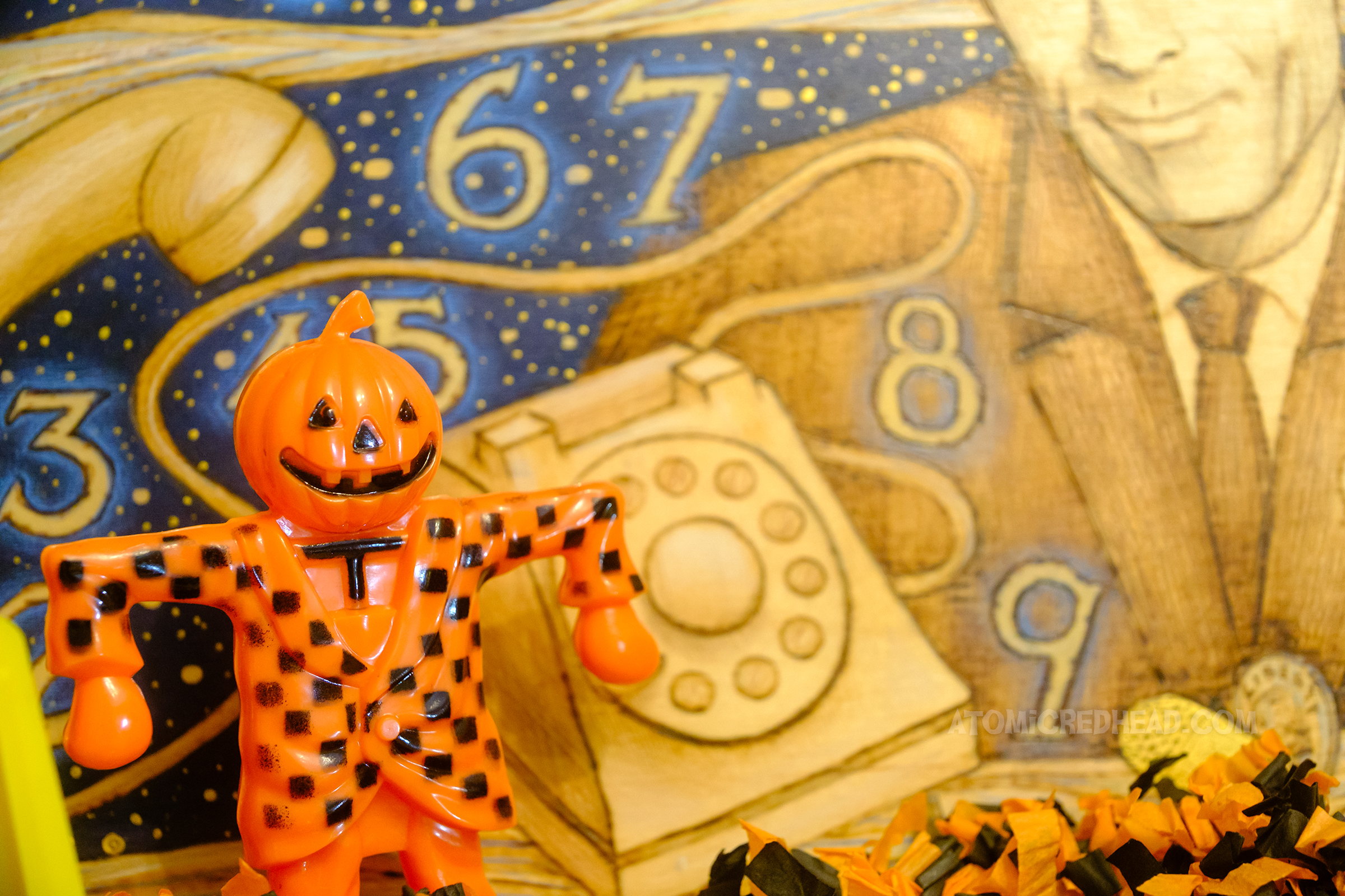Close-up of a small plastic scarecrow.