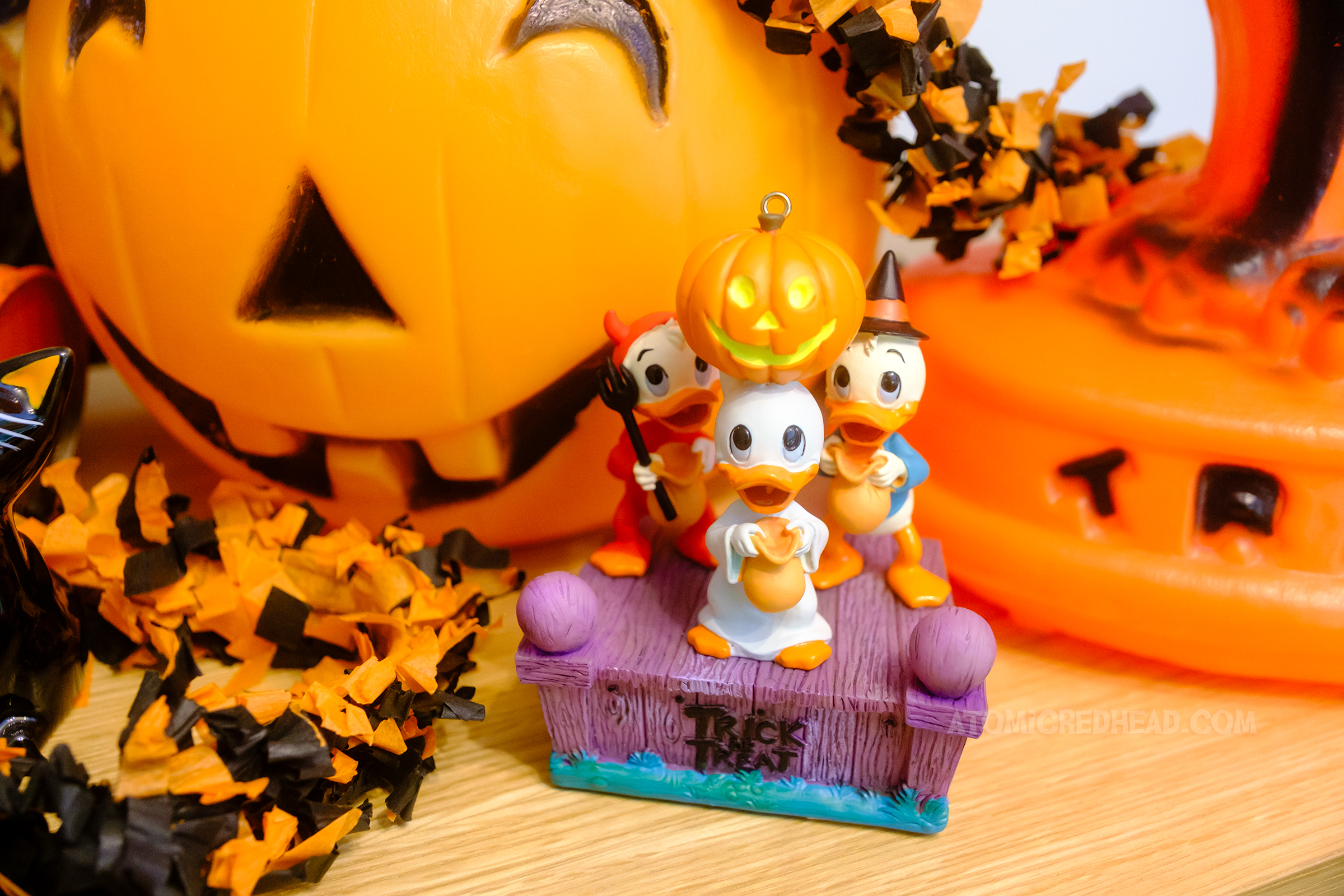 Close-up of a small ornament featuring Donald Duck's nephews, Huey, Dewy, and Louie dressed up for Halloween.