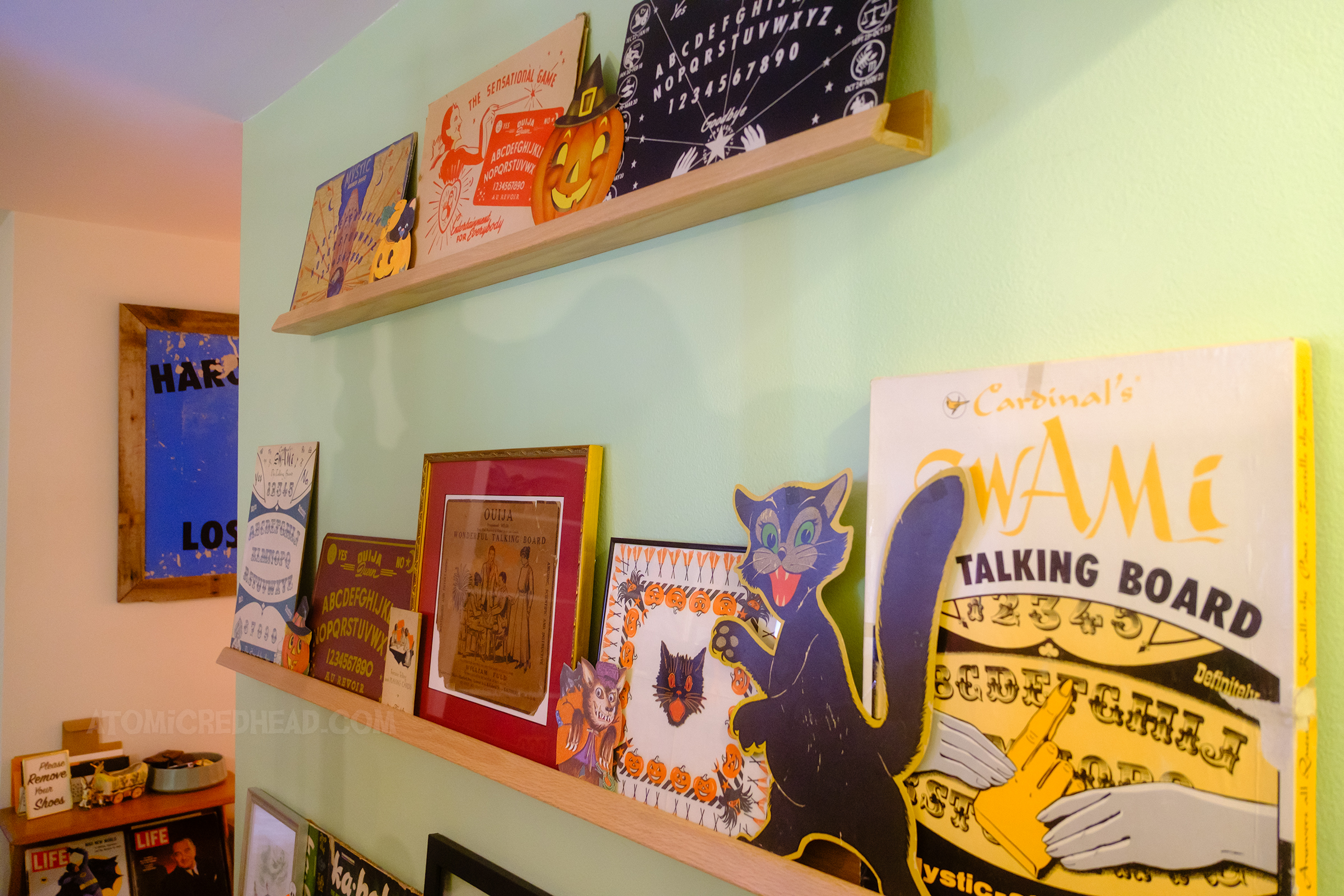 View of shallow shelves with various spirit boards on them.