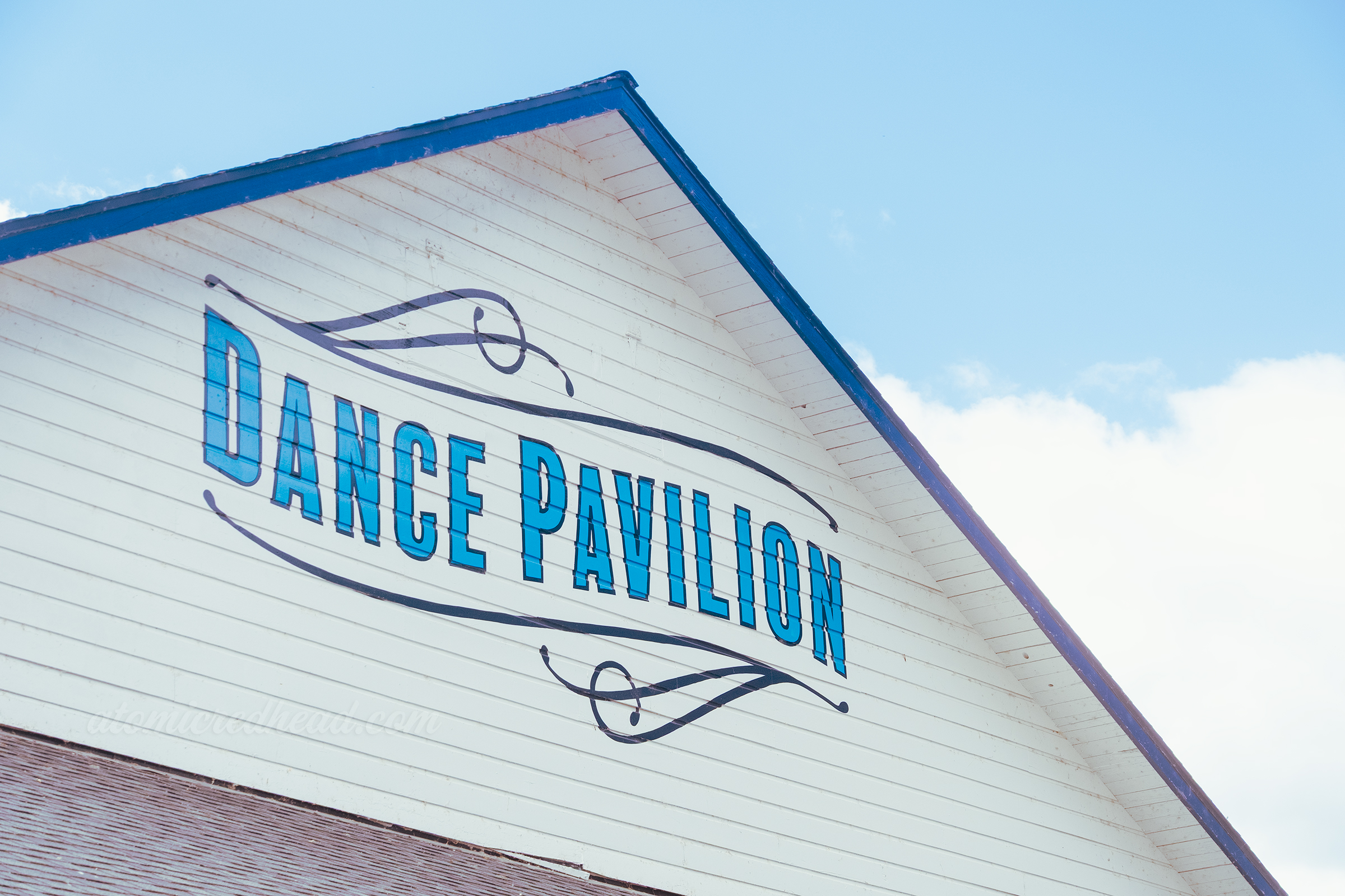 The Dance Pavilion, a white building with blue trim, in a lighter blue painted in large letters reads "Dance Pavilion"