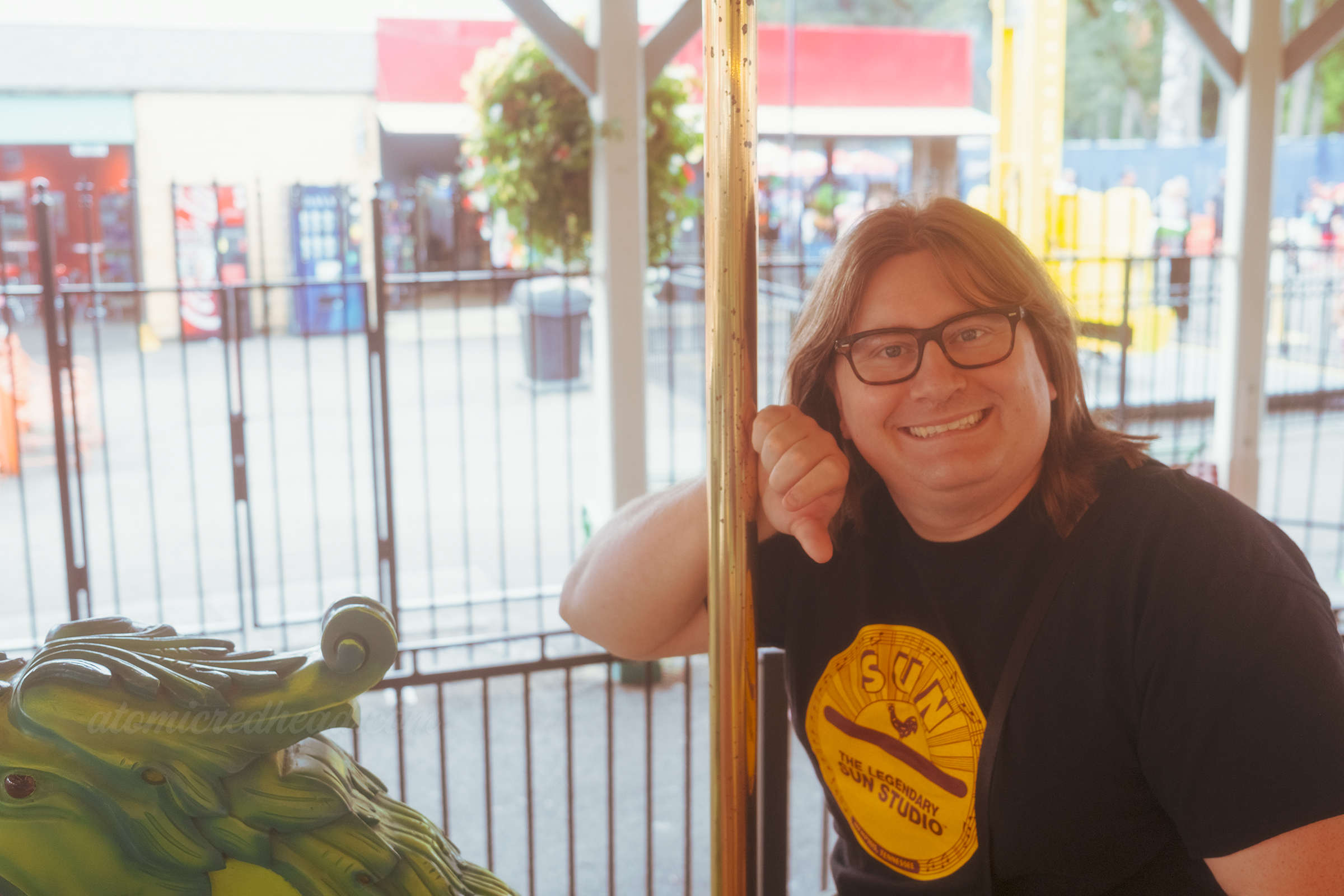 Patrick rides the sea dragon on the carousel.