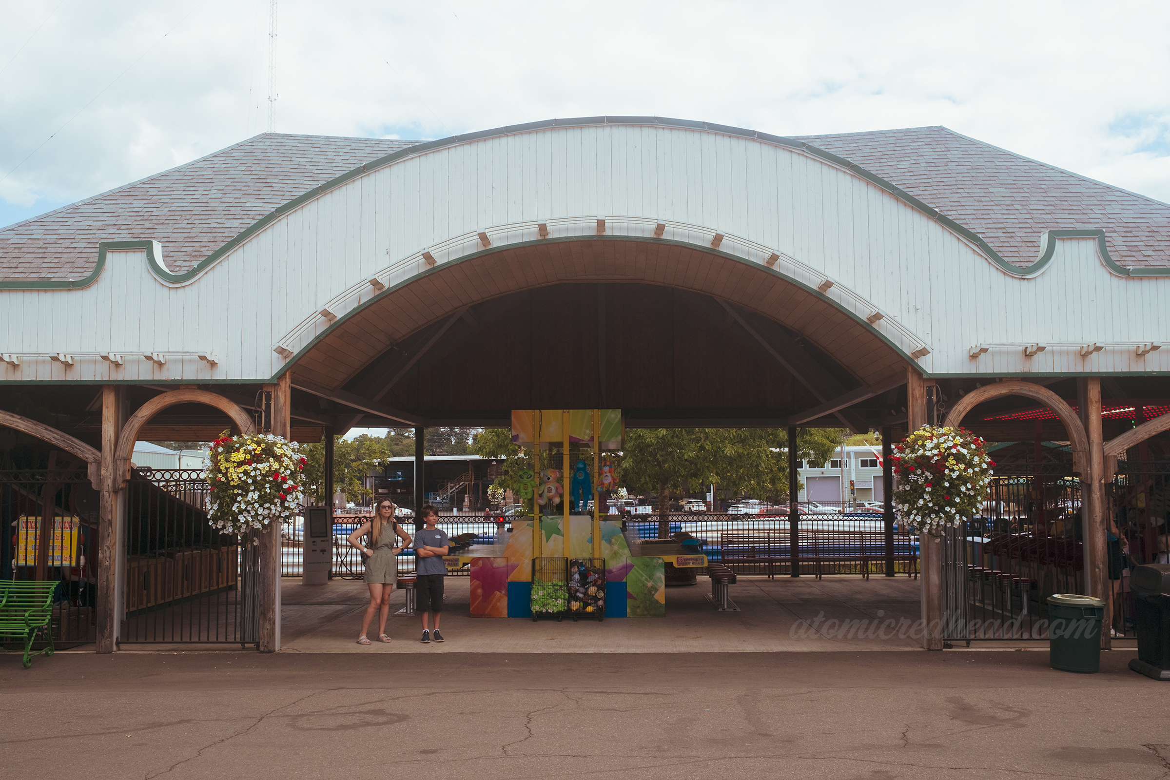 One of the old boardwalk buildings, arched with bulb lights around the edge and painted in white and teal.