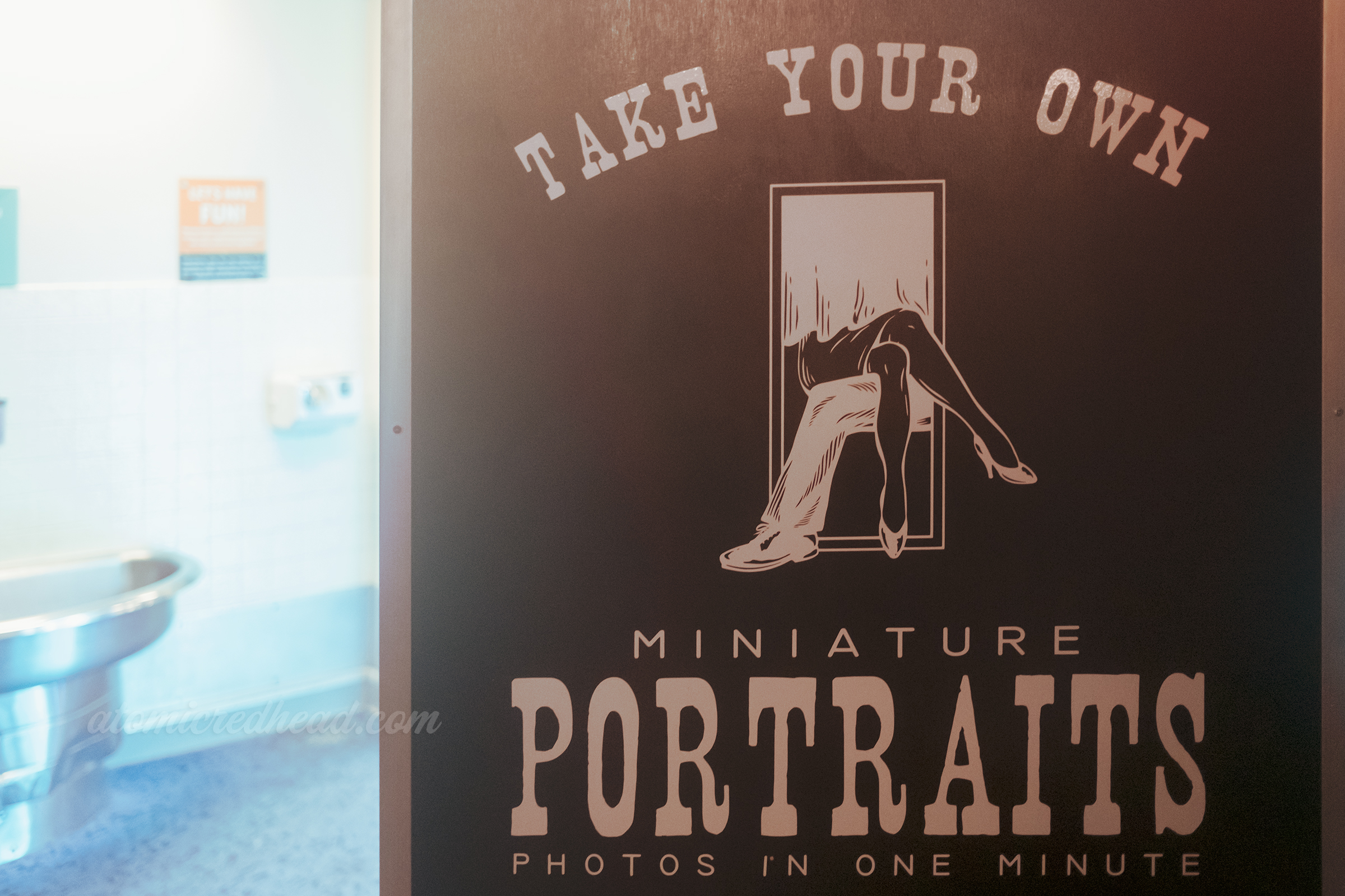 "Take Your Own Portraits" on the side of the photobooth at the roller rink.
