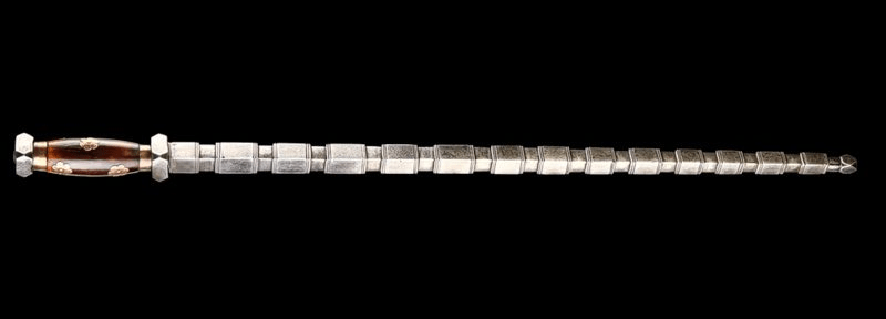 TIE BIAN (鐵鞭) 
Tie Bian, often shortened as simply Bian (鞭, whip), is a type of Chinese blunt weapon. It is a segmented solid metal rod with multiple prominent nodes, similar to bamboo, mounted on a sword hilt. The metal rod of Tie Bian usually has round cross section.
