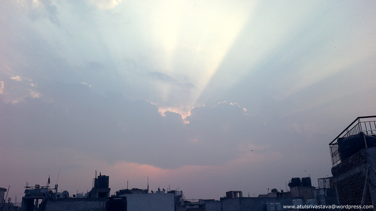 Silver lines coming through clouds casting sun on Sunday morning