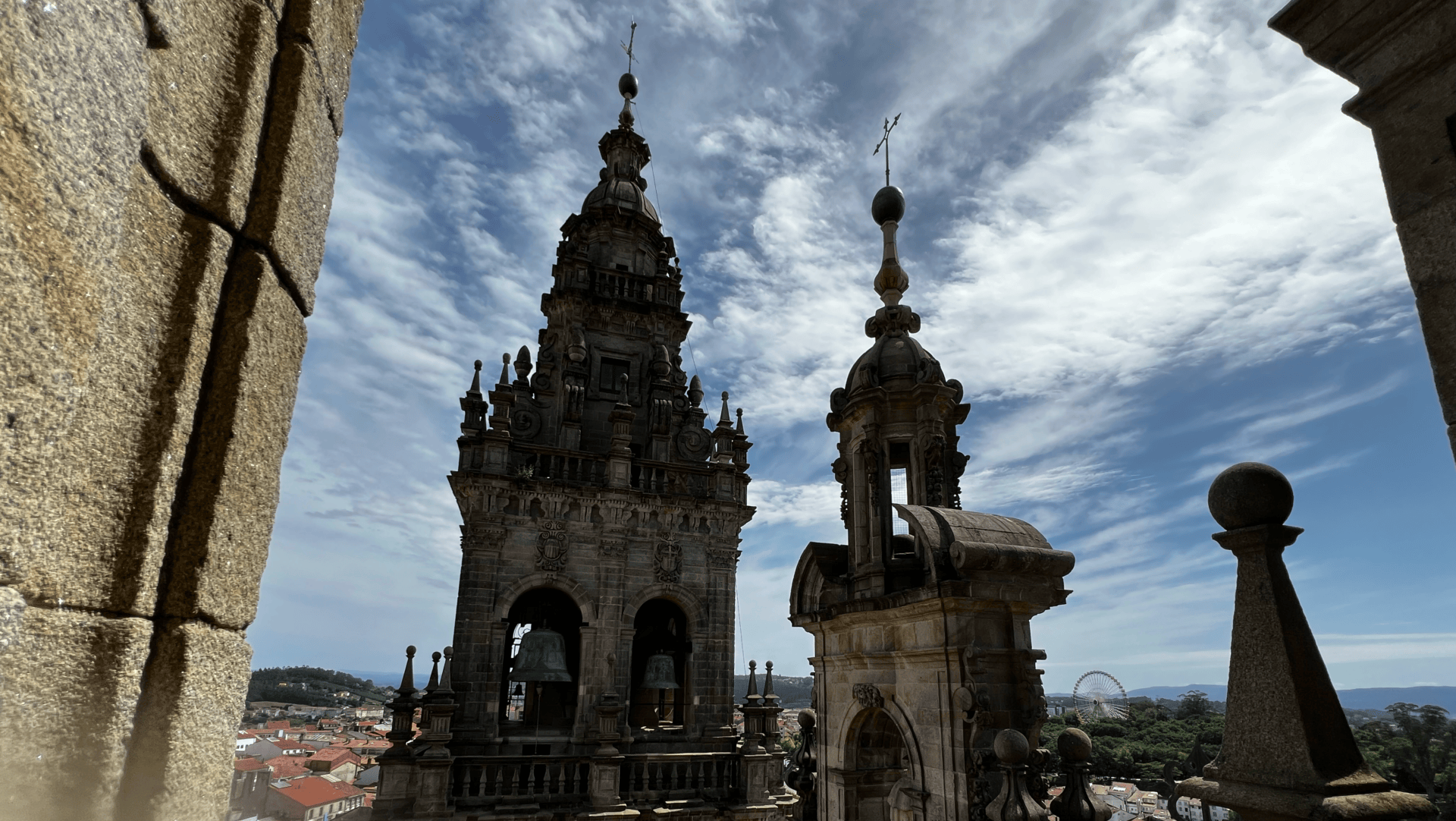 View of the Cathedral of Santiago de Compostela towers beneath a dramatic blue sky