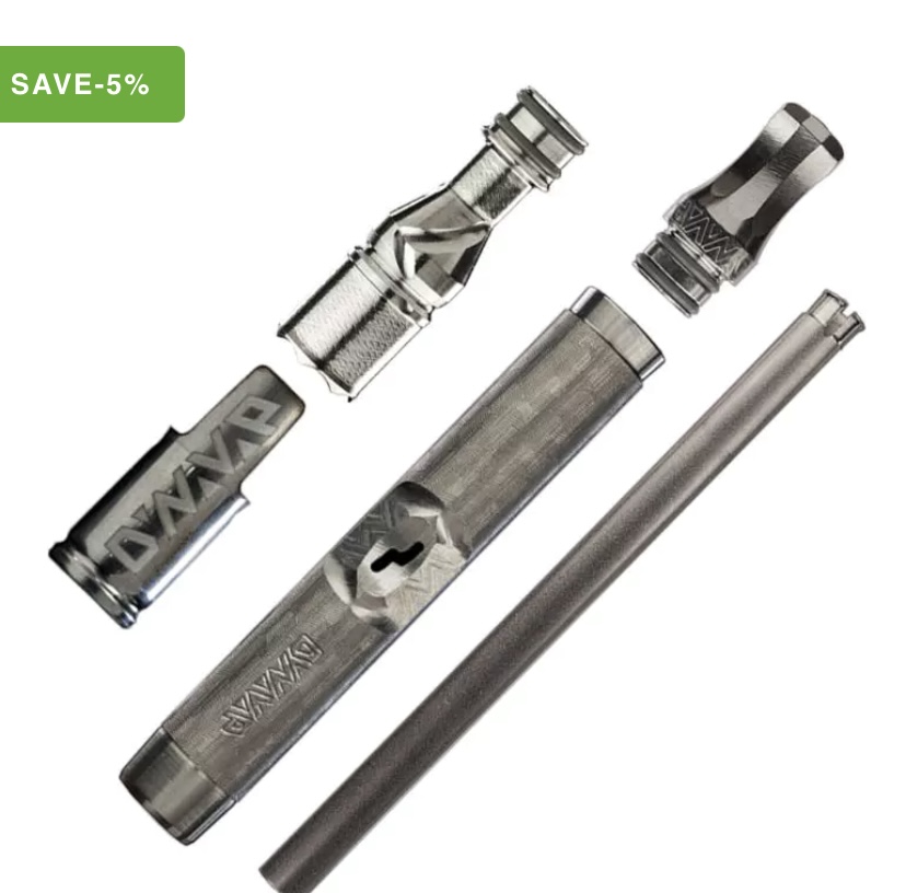 Disassembled vape tank components: glass tube, coil, top caps, and metal chamber laid out separately.