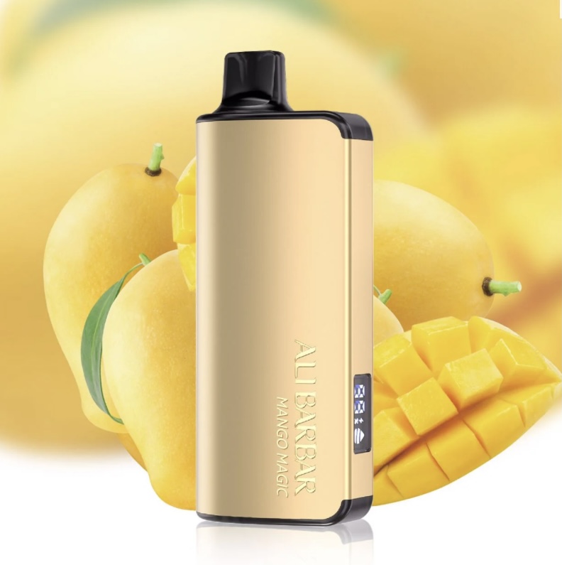Gold Vape Device with Black Mouthpiece Label aubbar Mango Magic Against a Mango Background with Sliced Mangoes Nearby - Australia E-cigarette Store