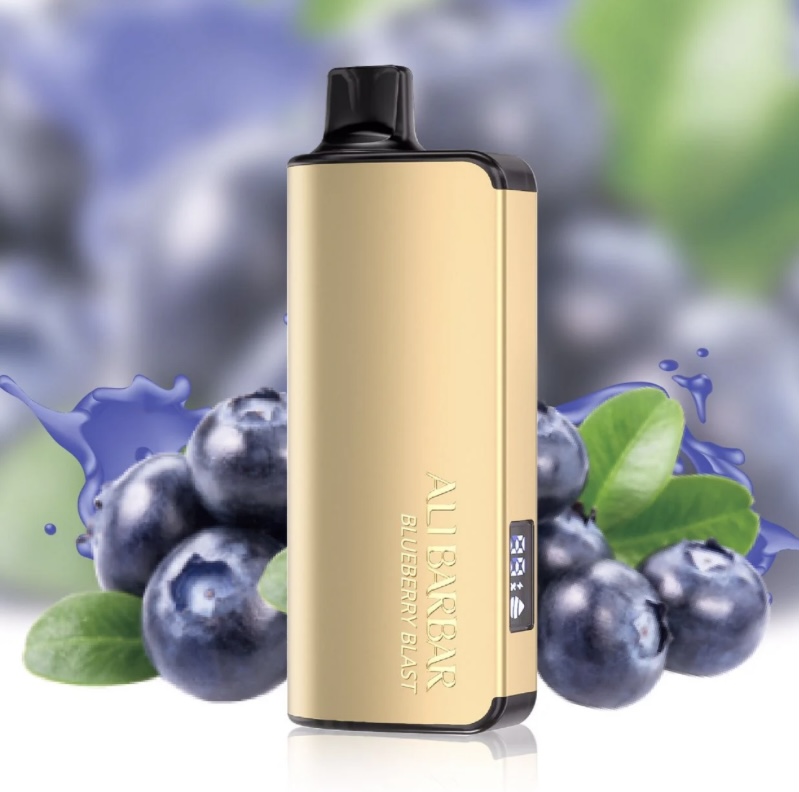 Gold Vape Device with a Blue Blueberry Flavor Label Standing Upright with Blueberries and Green Leaves in the Background - Flavor Blueberry Blast - Australia E-cigarette Store