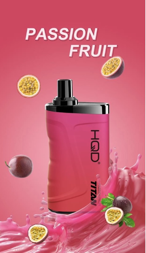 Pink perfume bottle with a black cap, surrounded by halved passion fruits and pink fruit splash to convey a passion-fruit scent theme.