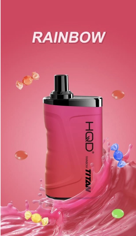 Pink perfume bottle with a black cap standing in a pink splashy scene; the word Rainbow appears above it on a pink gradient background, with candy-like droplets floating around.
