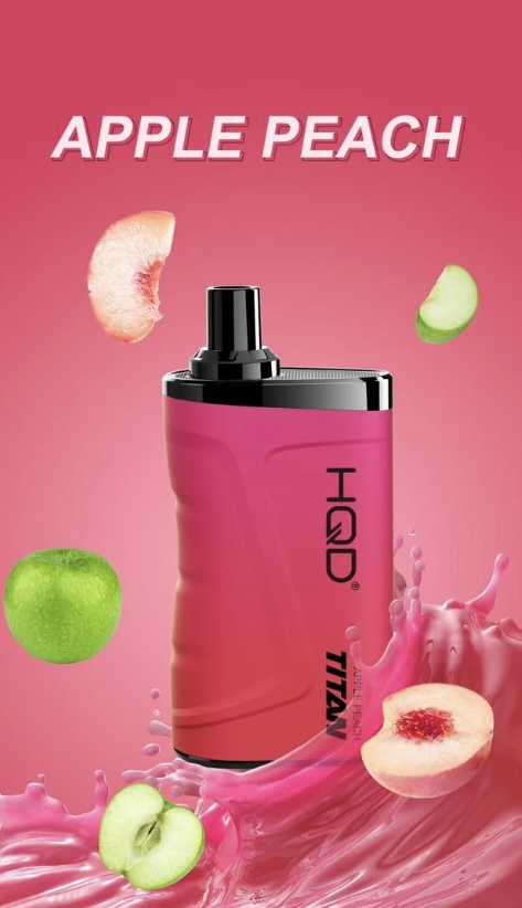 Bright pink Apple Peach perfume bottle surrounded by falling green apple and peach slices with a pink liquid splash in the background.