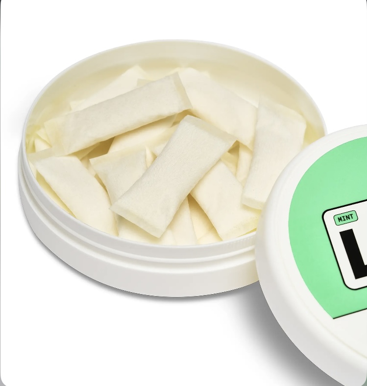 Round white tin opened to reveal rectangular white mint gum pieces stacked inside.