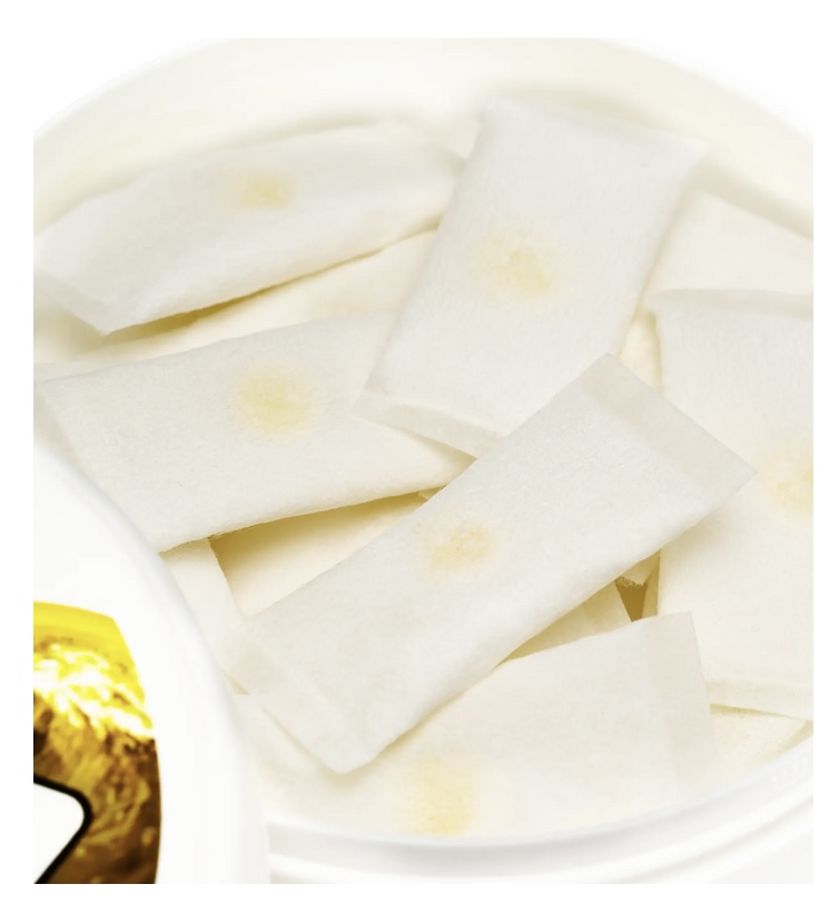 White rectangular crackers with pale yellow centers arranged in a white bowl.