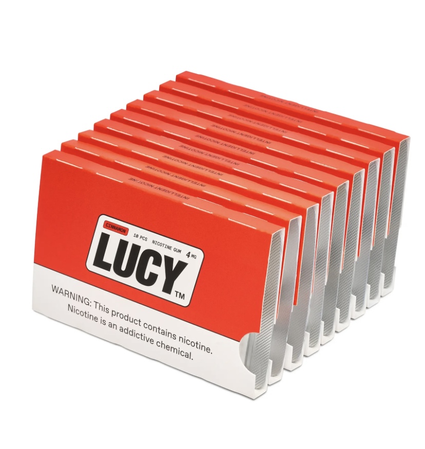 Stack of red and white Lucy nicotine gum boxes in cinnamon flavor, arranged in a row