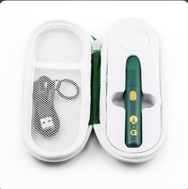 Open white zippered medical kit containing a green insulin pen-style device and a lancet/lancing tool in a mesh pocket.