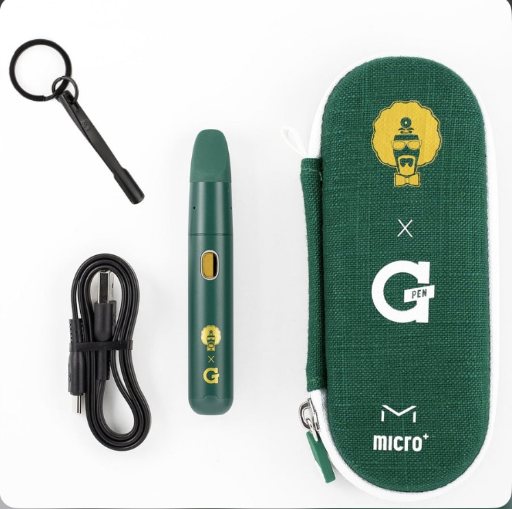 Green G Pen vape pen with yellow crest, USB charging cable, key ring, and green carrying case with G Pen branding on white background.