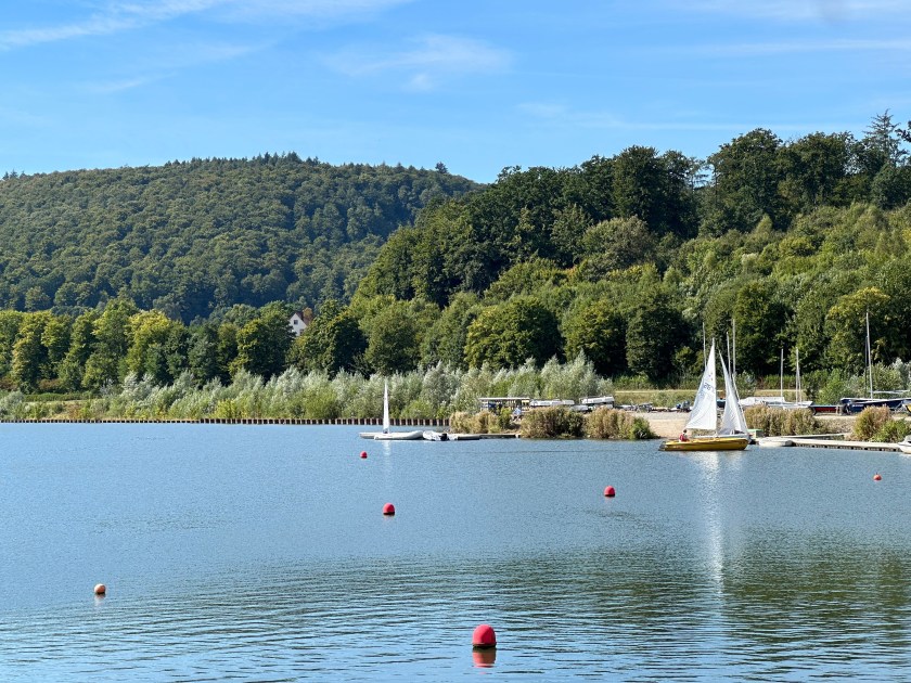 Segelboote auf dem Schiederstausee vor bewaldeten Hügeln