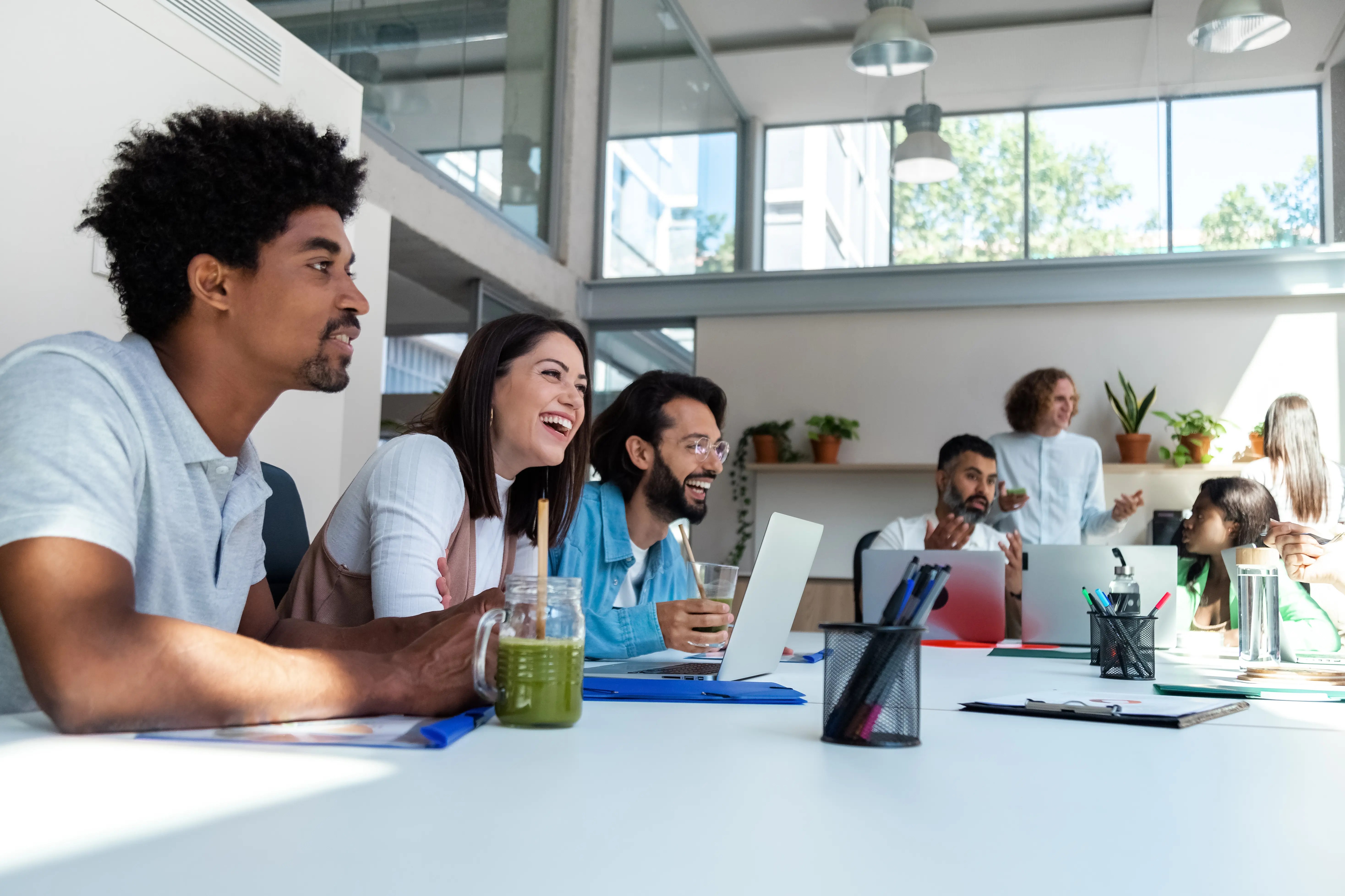 Diverse group of coworkers at the office sharing news. Talking. Copy space. Friendship at work concept. Business concept.